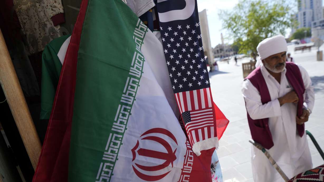 An Iranian flag and a scarf depicting U.S. flag are sold at the Souq Waqif Market in Doha, Qatar, Tuesday, Nov. 29, 2022.