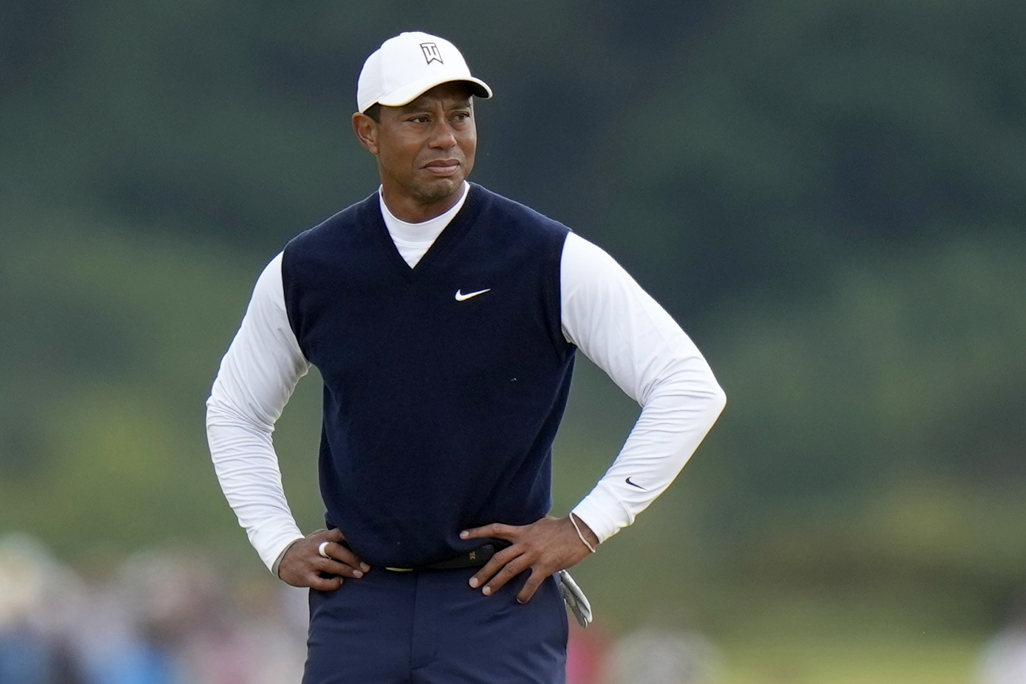 FILE - Tiger Woods, of the United States, stands on the 11th hole during the first round of the British Open golf championship on the Old Course at St. Andrews, Scotland, on July 14, 2022. Woods was out before he was officially back, withdrawing Monday, Nov. 28, 2022, from his Hero World Challenge with plantar fasciitis in his right foot. 