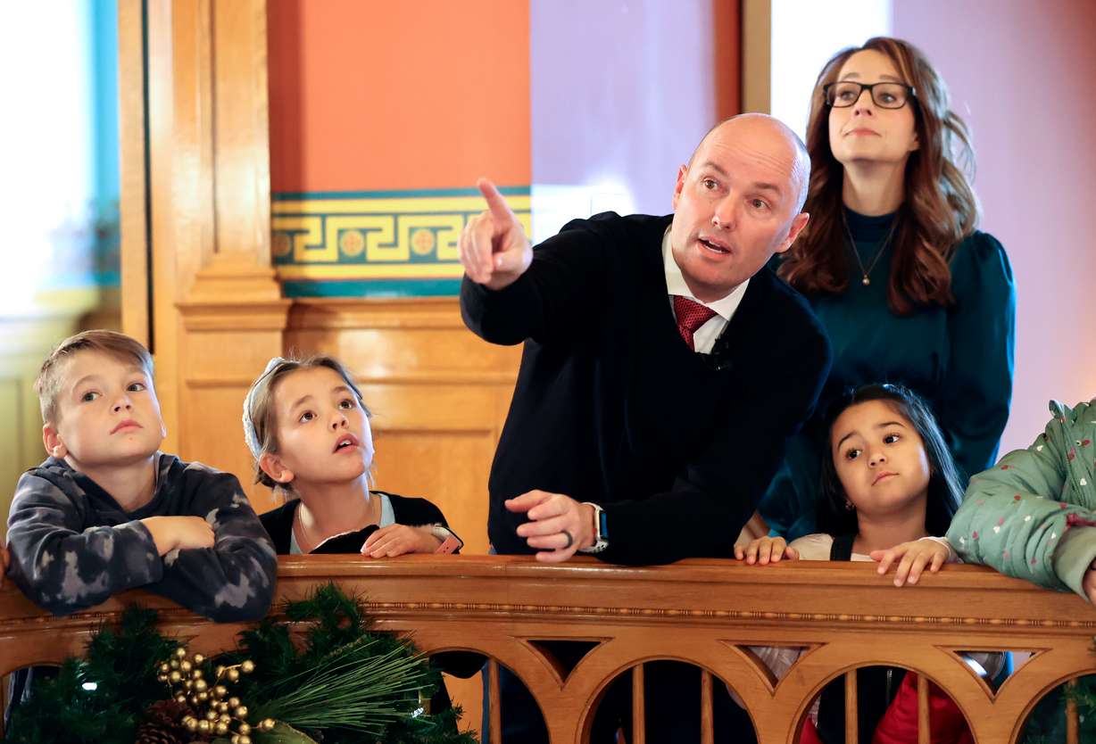 Gov. Spencer Cox tells Midvale Elementary fourth graders Jameson Albiston, Eden Bennett and Aliyah Magna Tovar about the history of the Governor’s Mansion as first lady Abby Cox listens at the Governor’s Mansion in Salt Lake City on Tuesday.