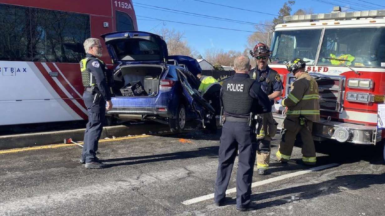 Police respond to a crash involving a car and a TRAX train in West Valley City on Tuesday.