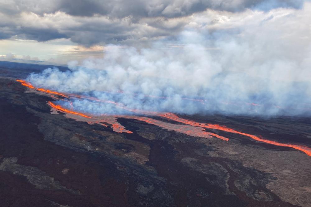 The Mauna Loa volcano is seen erupting from vents on the Northeast Rift Zone on the Big Island of Hawaii, Monday. Hawaii's Mauna Loa, the world's largest active volcano, began spewing ash and debris from its summit, prompting civil defense officials to warn residents on Monday to prepare in case the eruption causes lava to flow toward communities.