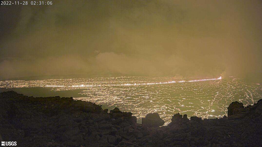 This image shows a view from a research camera on the north rim of the summit caldera of the Mauna Loa volcano, Monday. The U.S. Geological Survey says the eruption began late Sunday night in the summit caldera of the volcano on the Big Island. Early Monday it said lava flows were contained within the summit area and weren’t threatening nearby communities.
