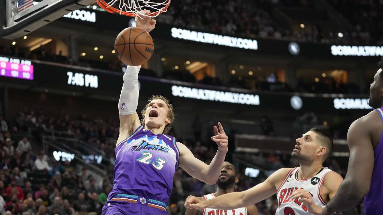 Utah Jazz forward Lauri Markkanen (23) dunks as Chicago Bulls center Nikola Vucevic (9) looks on during the first half of an NBA basketball game Monday, Nov. 28, 2022, in Salt Lake City.