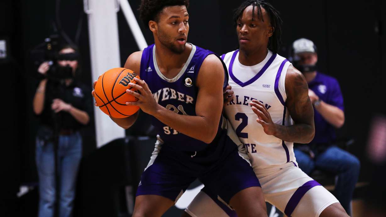 Weber State forward Daniel Rouzan (21) posts up against a Tarleton State defender in a game the Wildcats lost 75-65 on Nov. 29, 2022.