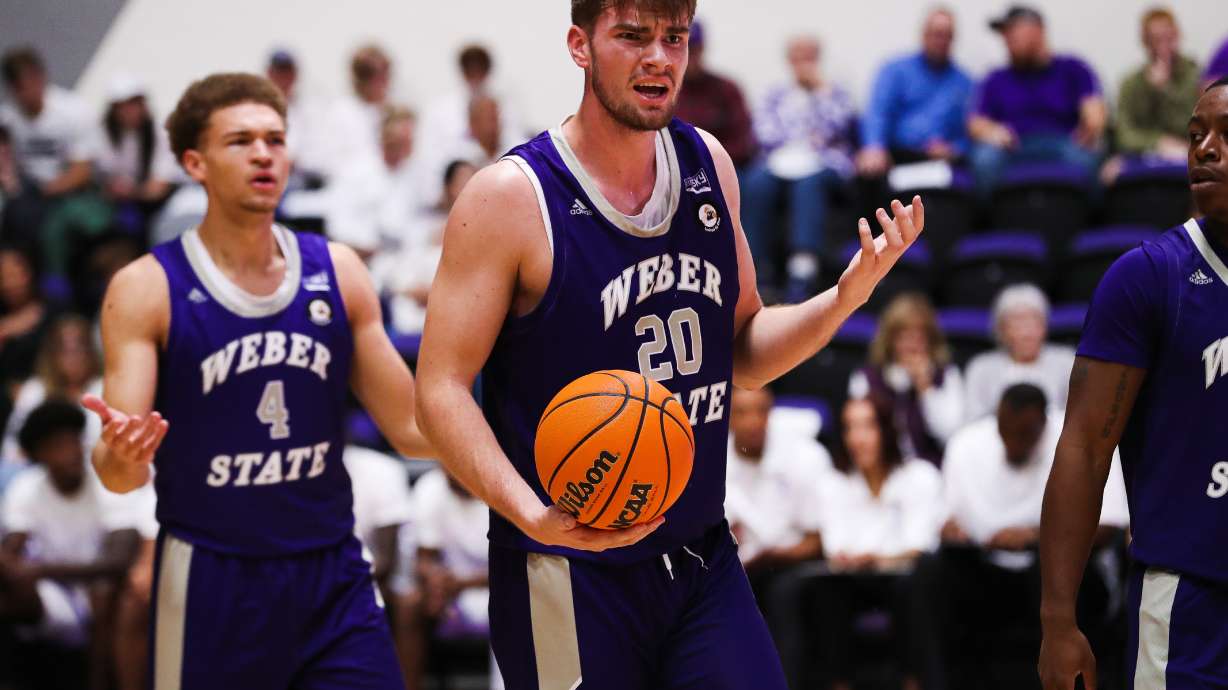 Weber State center Alex Tew (20) and forward Dyson Koehler (4) question a referee's call in a game on Nov. 29, 2022.