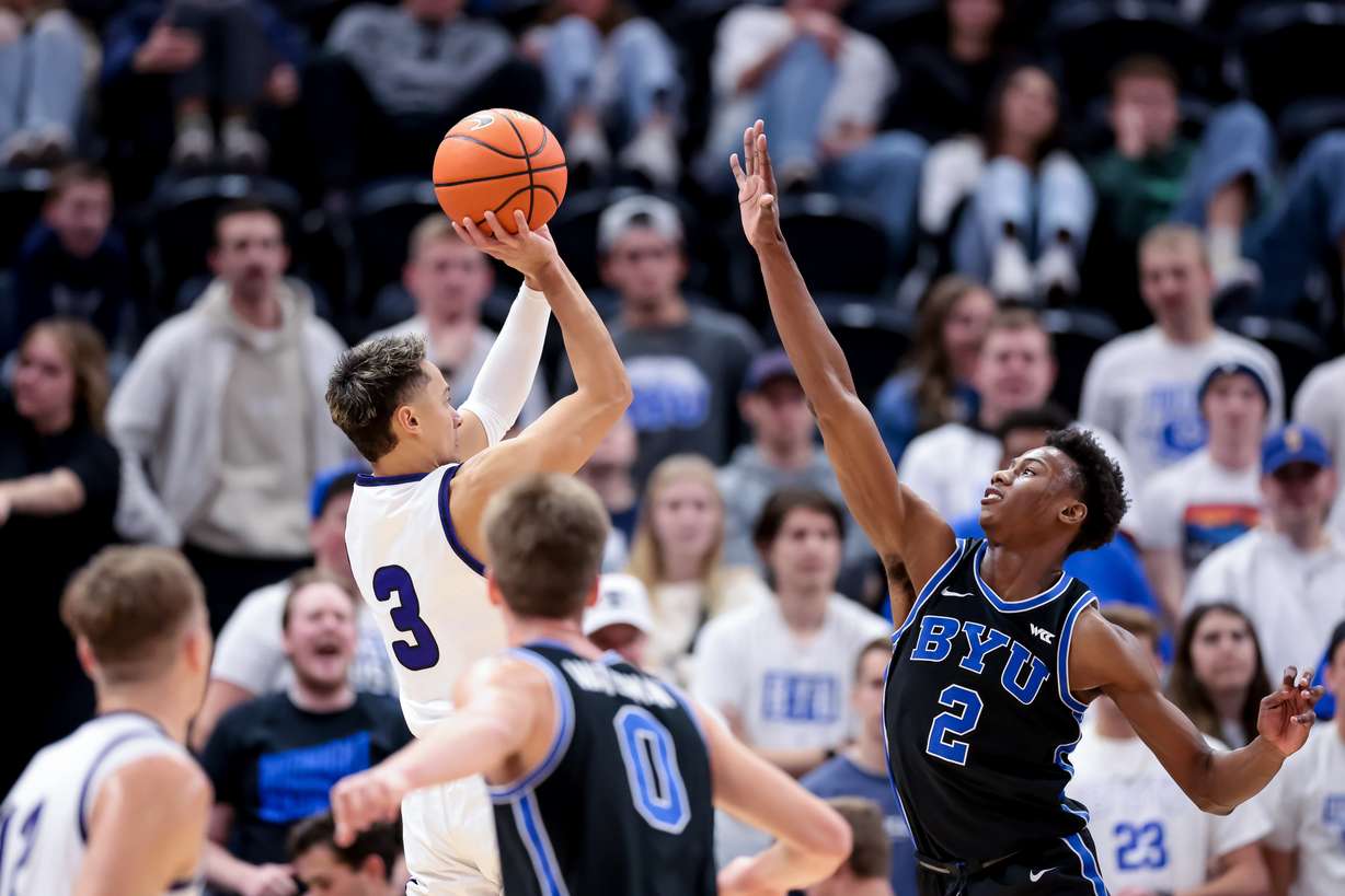 Westminster guard Taylor Miller (3) shoots over BYU guard Jaxson Robinson (2) during the game at Vivint Arena in Salt Lake City on Tuesday, Nov. 29, 2022.