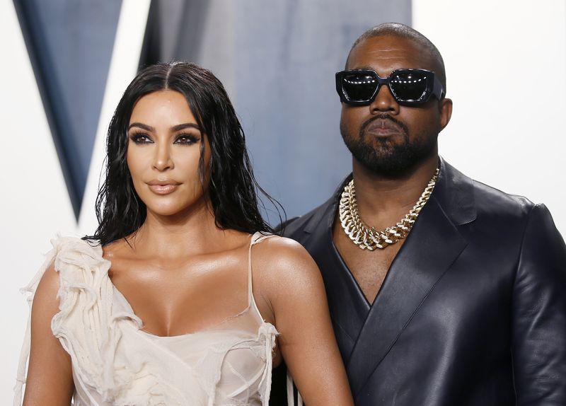 Kim Kardashian and Kanye West attend the Vanity Fair Oscar party in Beverly Hills during the 92nd Academy Awards, in Los Angeles, California Feb. 9, 2020. The former couple have reached a divorce settlement that includes joint custody of their four children and dividing up their real estate assets.