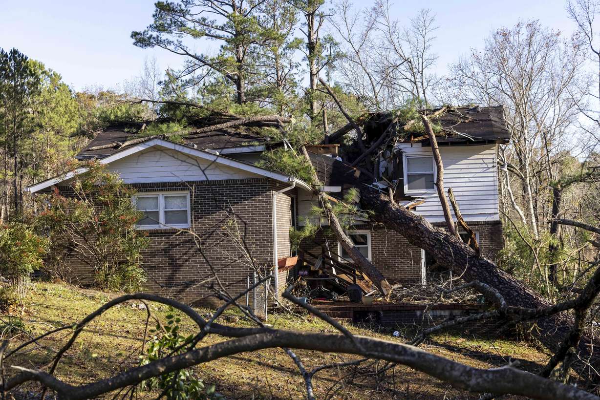 Wes Garner's residence is damaged by fallen trees which also destroyed his shed and caused a gas leak following Tuesday night's severe weather, Wednesday in Eutaw, Ala.