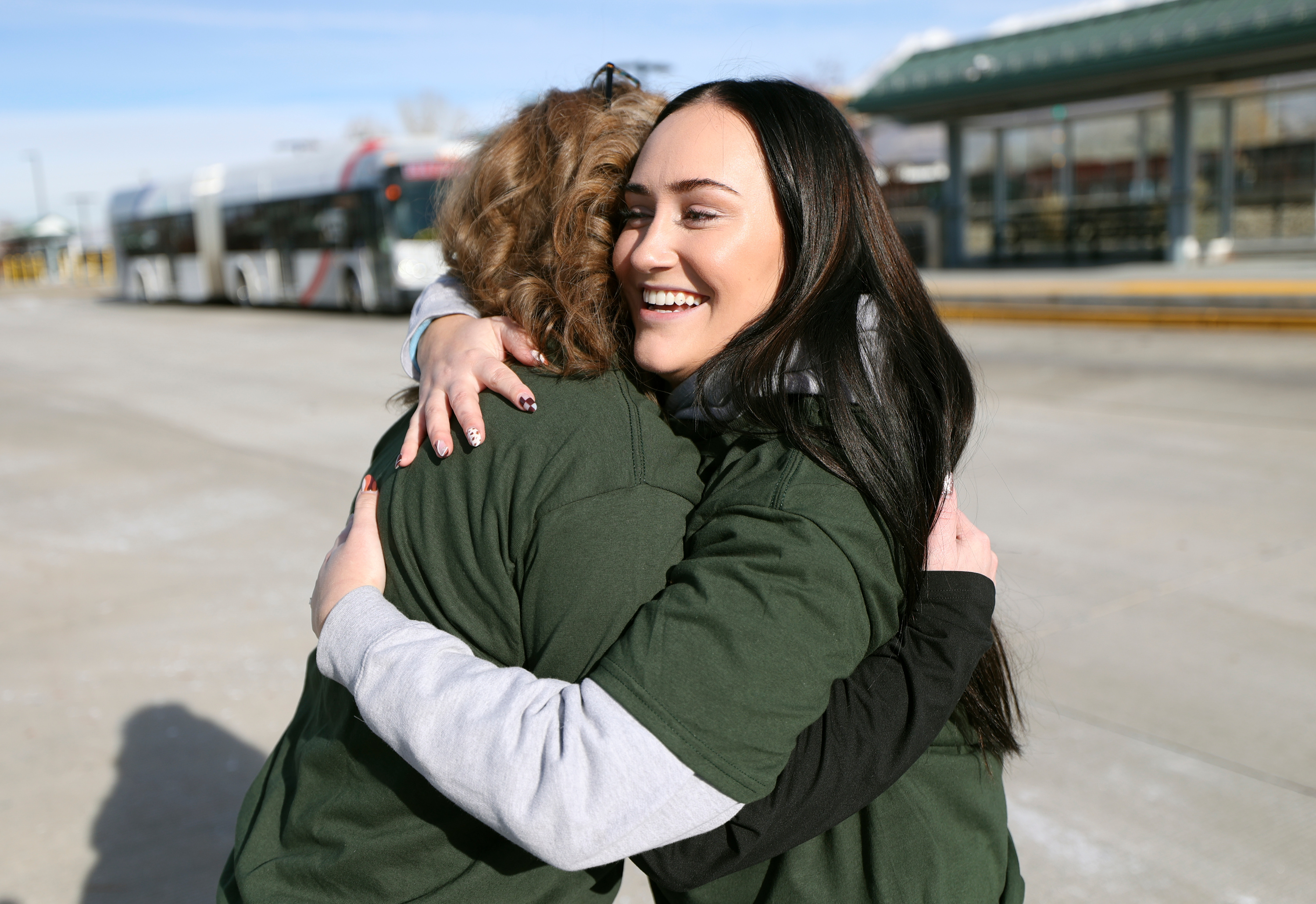 Utah Valley University students Ashley Jones, left, and Caitlyn Bennett, who has severe asthma and vocal cord disfunction, hug after speaking at a press conference about the Give the Gift of Clean Air campaign at the Utah Transit Authority Orem Central Station in Orem on Wednesday. UVU students and staff were to urged to pledge to ride public transit to improve Utah air quality.