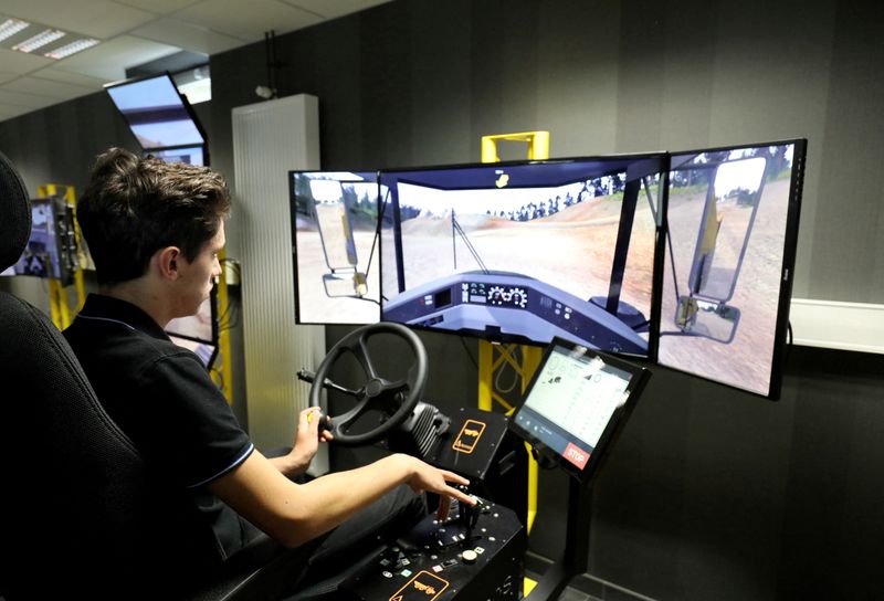 A student uses a driving simulator for civil engineering machines during a visit of the French president to The School of Application to the Trades of Public Works, which is devoted to apprenticeship and vocational training in Egletons, France, October 4, 2017.