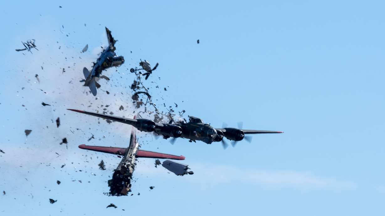 A Boeing B-17 Flying Fortress and a Bell P-63 Kingcobra collide in midair during an airshow at Dallas Executive Airport in Dallas, Nov. 12. A preliminary report says no guidance was given on altitudes before the plane crashed into the bomber.