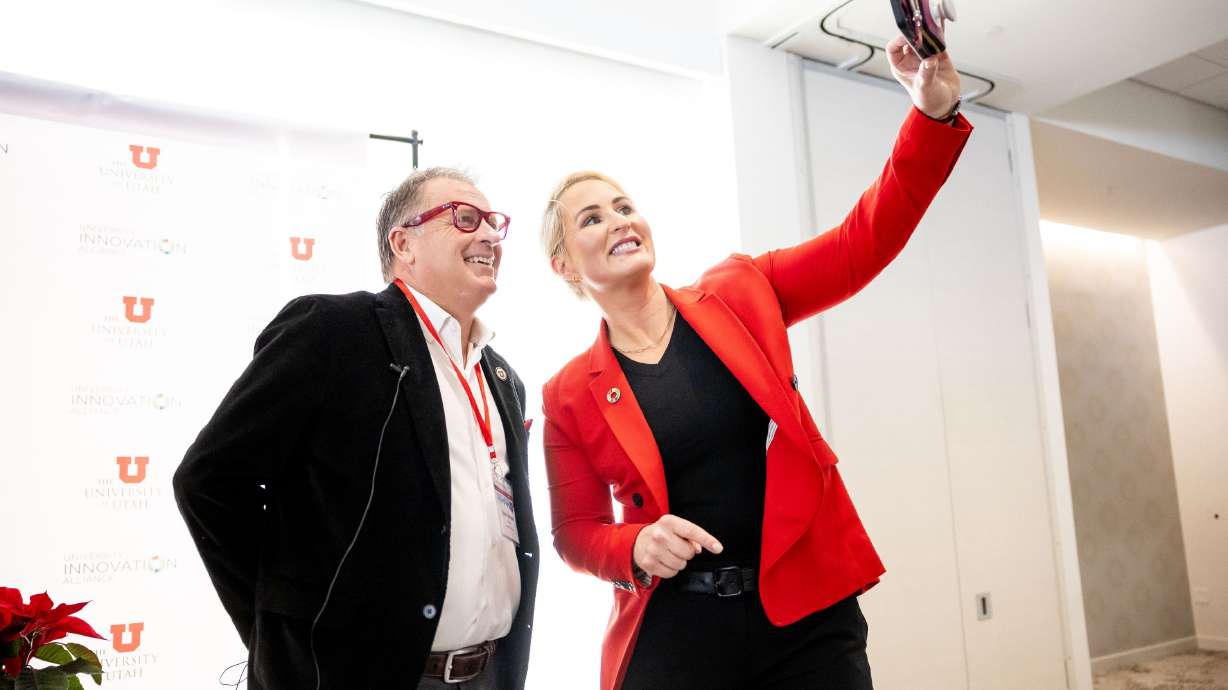 University of Utah President Taylor Randall, left, and Bridget Burns, CEO of University Innovation Alliance, take a selfie before holding a fireside chat at the Student Success Summit at the university in Salt Lake City on Wednesday.