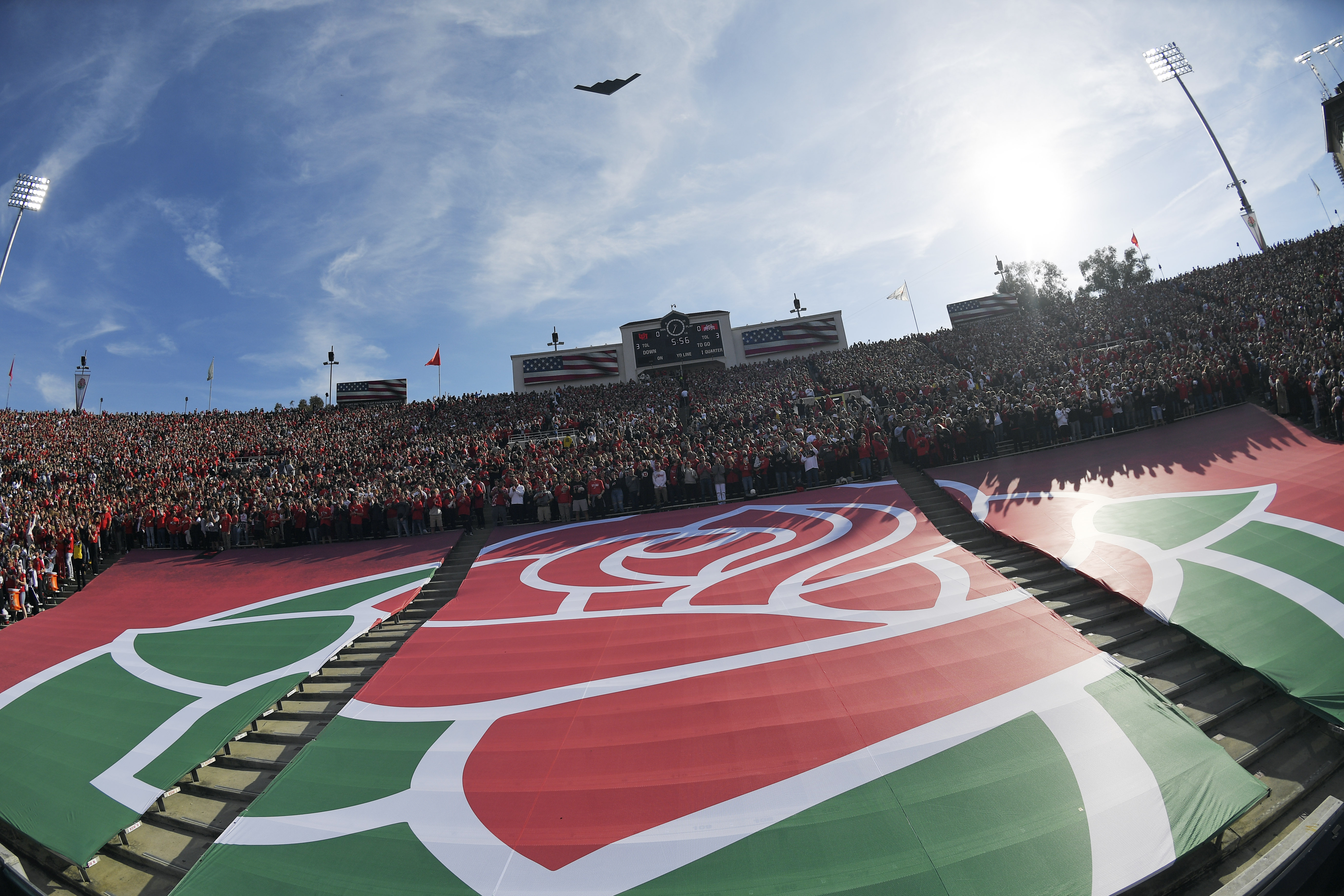 The Rose Bowl logo is seen during a fly over before the Rose Bowl NCAA college football game between Utah and Ohio State Saturday, Jan. 1, 2022, in Pasadena, Calif. Flipping the current college football playoff from four-teams to a 12-teams for the final two years of the current television contract will give those in charge of the postseason a look at how it works before committing to anything long term. But, The Granddaddy of Them All wants the CFP management committee to assure game organizers that their game will continue to be played annually on New Year's Day. 