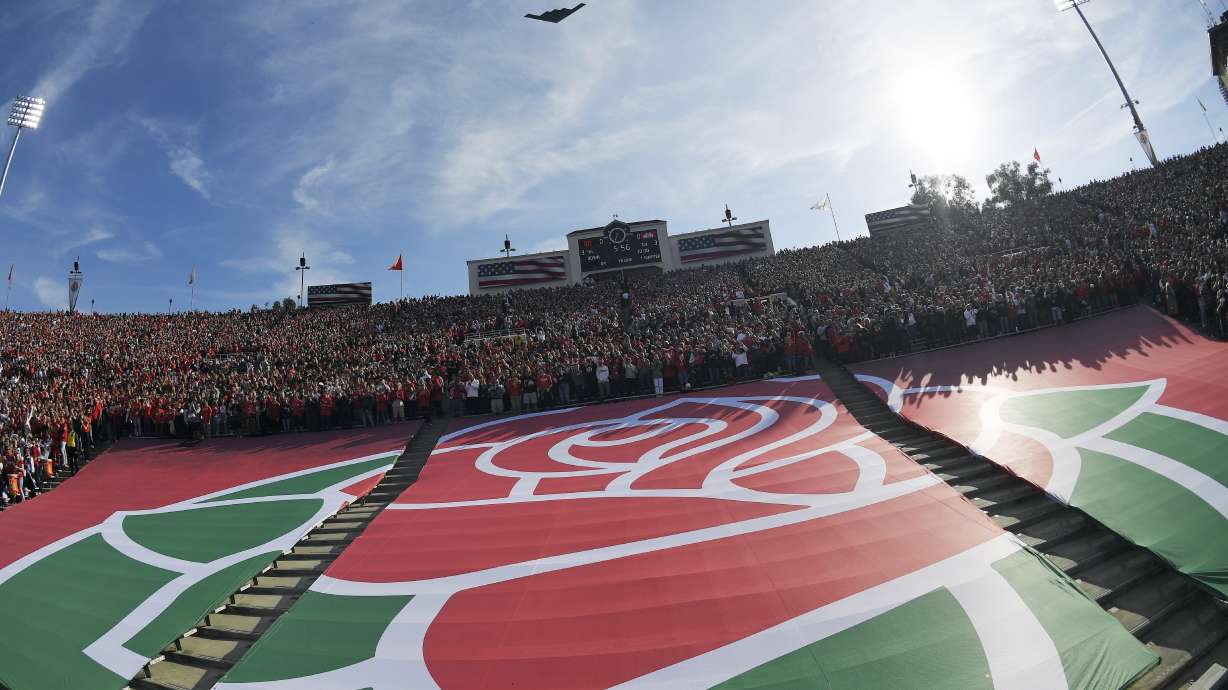The Rose Bowl logo is seen during a fly over before the Rose Bowl NCAA college football game between Utah and Ohio State Saturday, Jan. 1, 2022, in Pasadena, Calif. Flipping the current college football playoff from four-teams to a 12-teams for the final two years of the current television contract will give those in charge of the postseason a look at how it works before committing to anything long term. But, The Granddaddy of Them All wants the CFP management committee to assure game organizers that their game will continue to be played annually on New Year's Day.