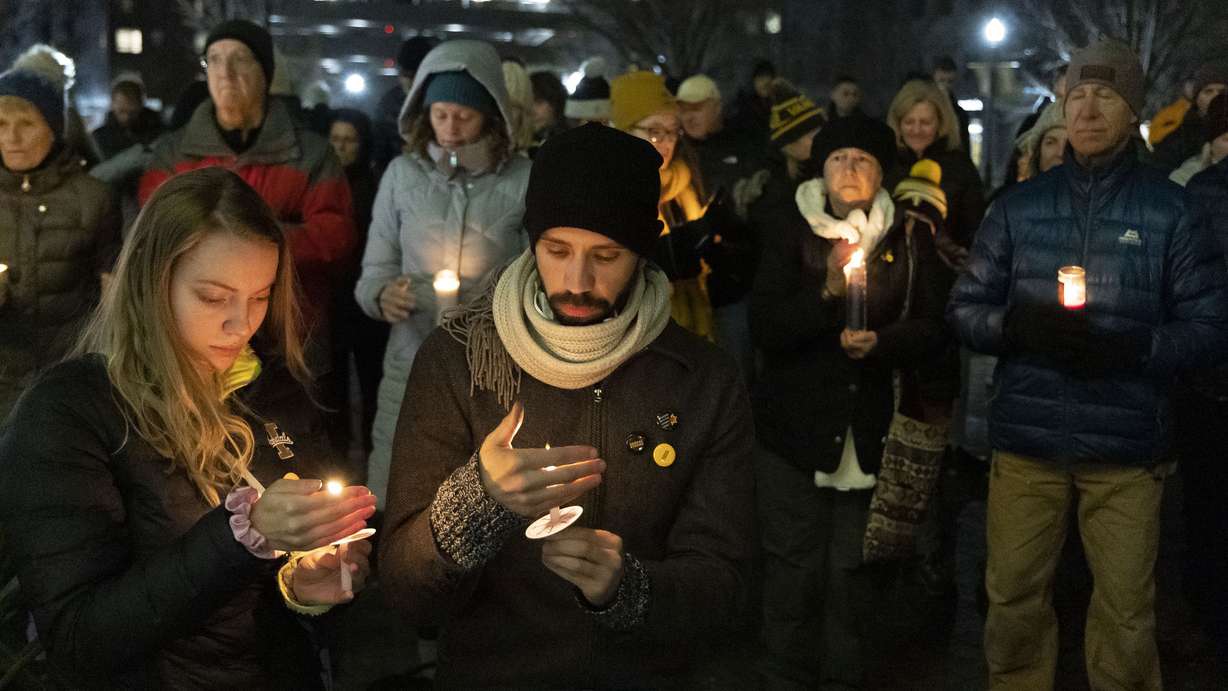 People attend a vigil at the University of Idaho Boise Campus, Wednesday in downtown Boise, Idaho, to honor the four students killed in Moscow, Idaho, earlier this month.
