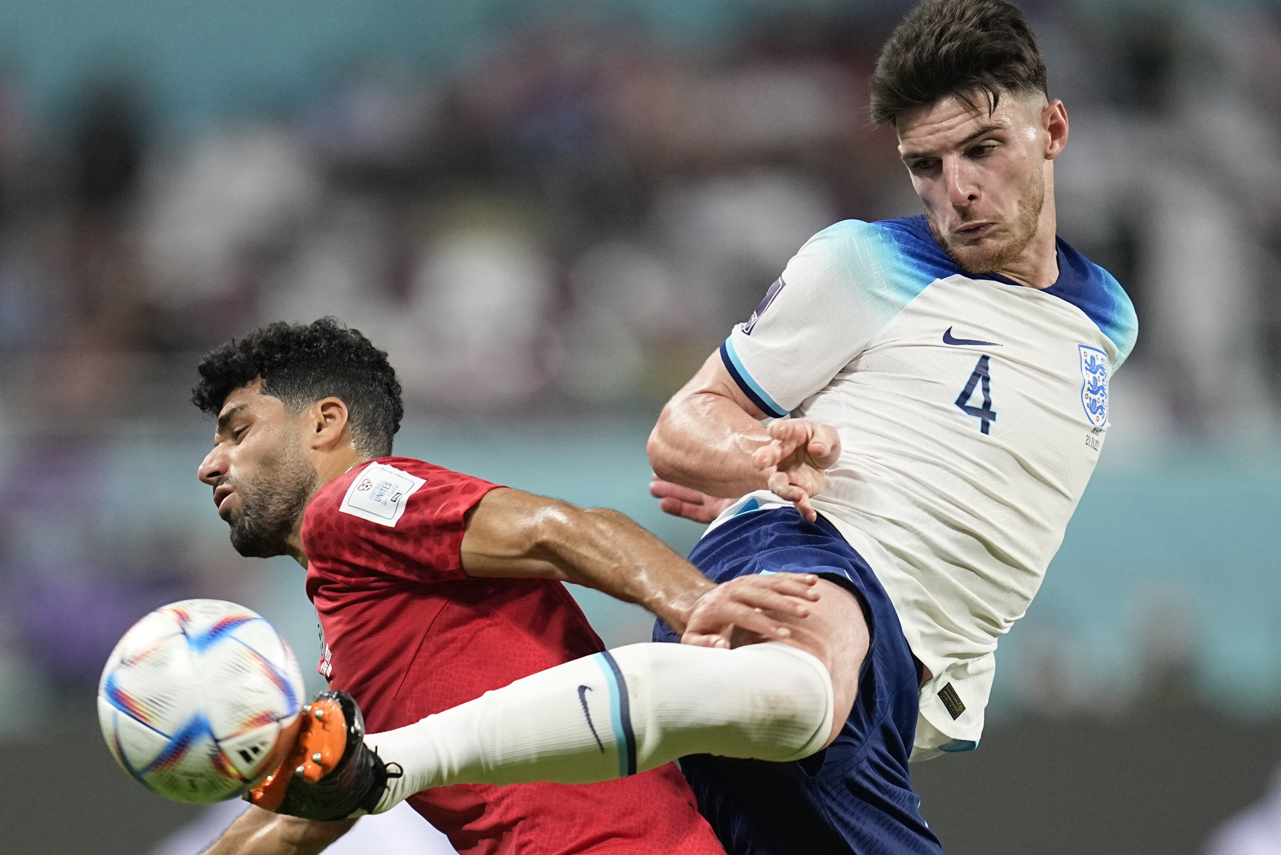 England's Declan Rice, right, kicks the ball past Iran's Mehdi Taremi during the World Cup group B soccer match between England and Iran at the Khalifa International Stadium in Doha, Qatar, Monday, Nov. 21, 2022. 