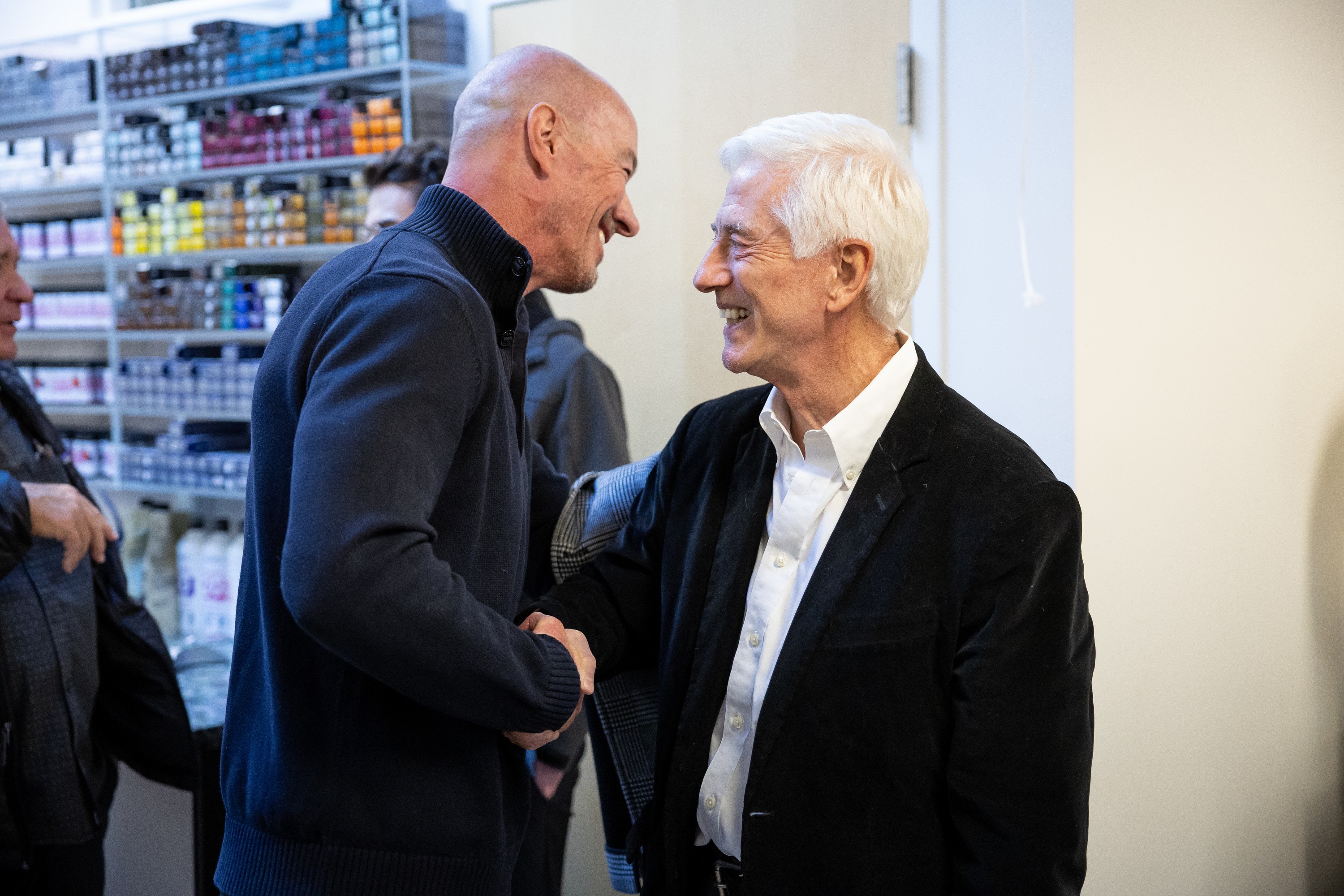 Former Salt Lake City Police Chief Chris Burbank, left, shakes hands with former Mayor Rocky Anderson after Anderson announced that he is once again running for mayor during an event at Cake Salon in Salt Lake City on Wednesday, Nov. 30, 2022.