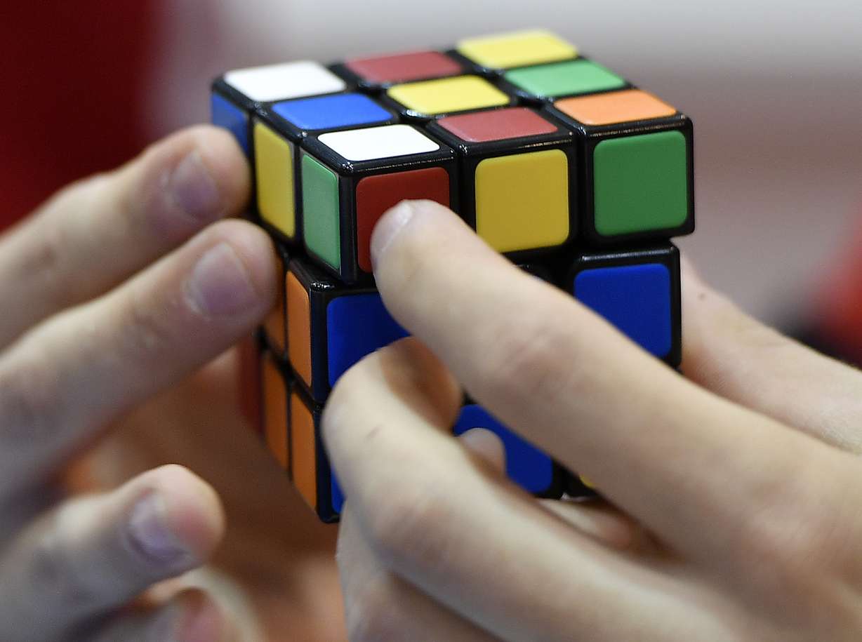 A gamer plays with Rubik's Magic Cube at the international game fair 'SPIEL' in Essen, Germany, on Oct. 26, 2017.