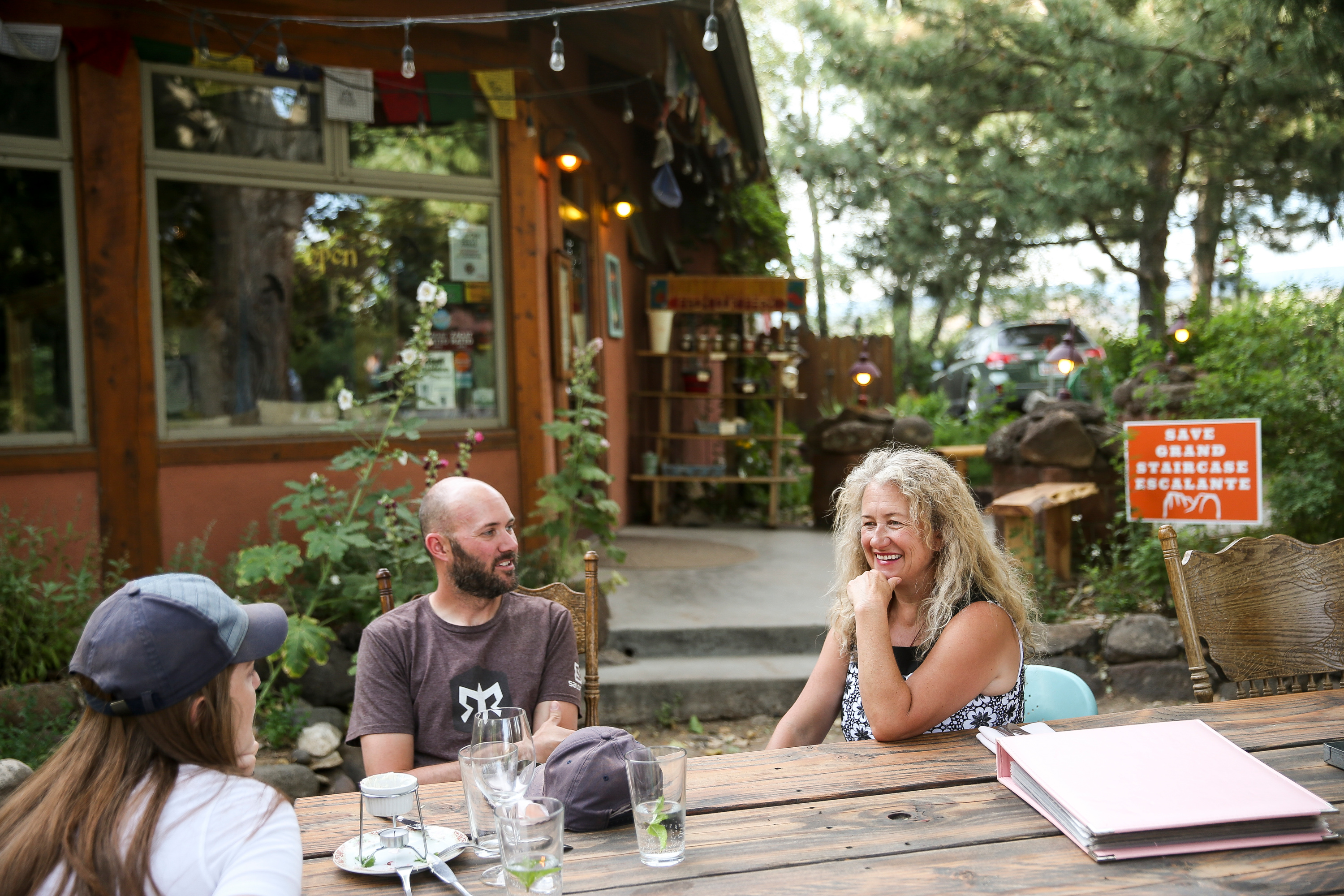 Blake Spalding, chef and co-owner of Hell's Backbone Grill and Farm, right, sits with diners outside the restaurant in Boulder, Garfield County, on Aug. 10, 2017. A restaurant that has been a staple of southern Utah for the last 23 years, serving organic, locally produced, regionally and seasonally appropriate cuisine, is at risk of shutting its doors for good. Now, it's asking for the community's help to stay open.