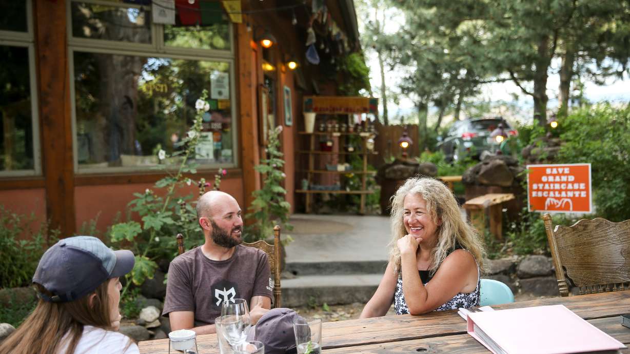 Blake Spalding, chef and co-owner of Hell's Backbone Grill and Farm, right, sits with diners outside the restaurant in Boulder, Garfield County, on Aug. 10, 2017. A restaurant that has been a staple of southern Utah for the last 23 years, serving organic, locally produced, regionally and seasonally appropriate cuisine, is at risk of shutting its doors for good. Now, it's asking for the community's help to stay open.
