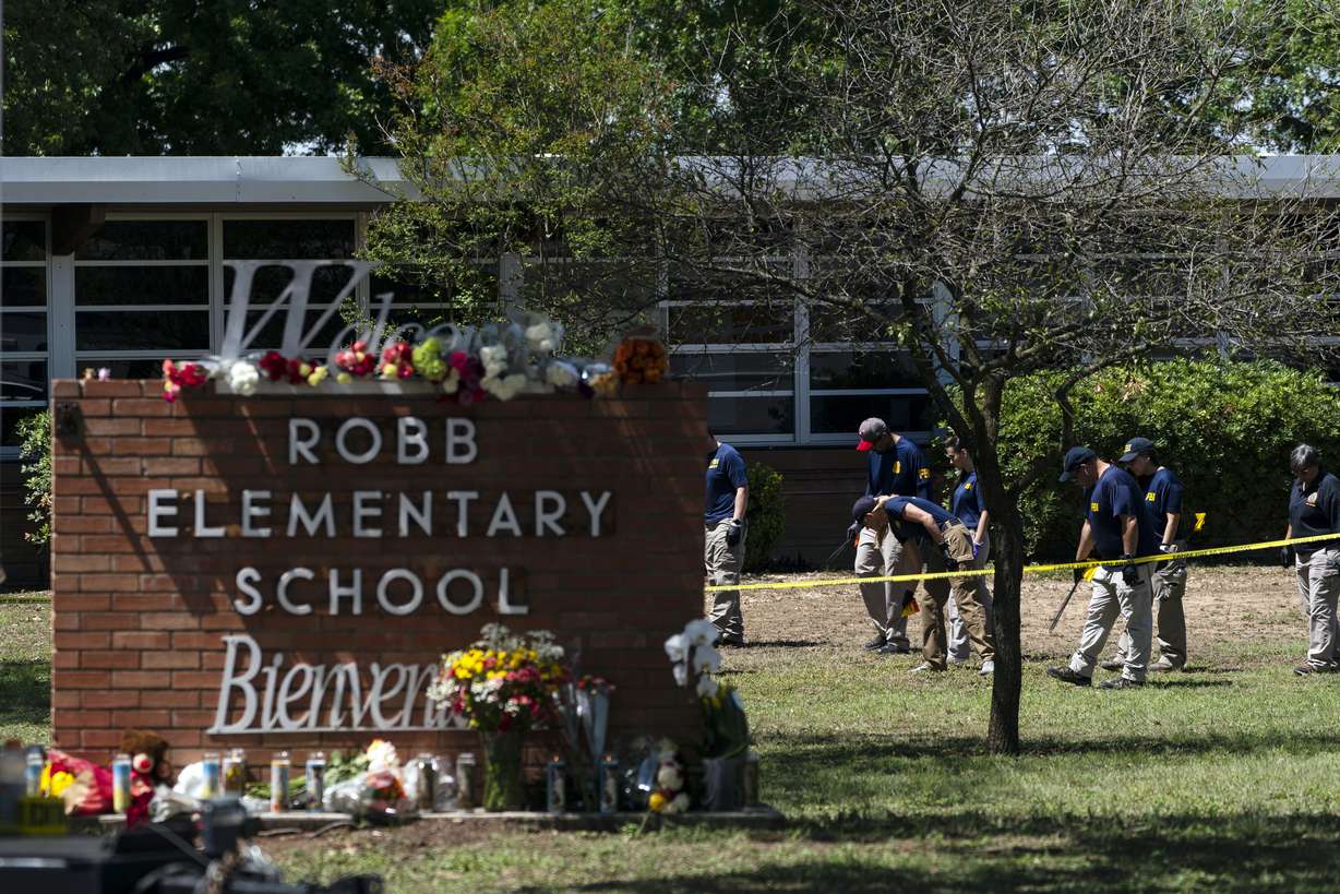Investigators search for evidence outside Robb Elementary School in Uvalde, Texas, May 25, after an 18-year-old gunman killed 19 students and two teachers.