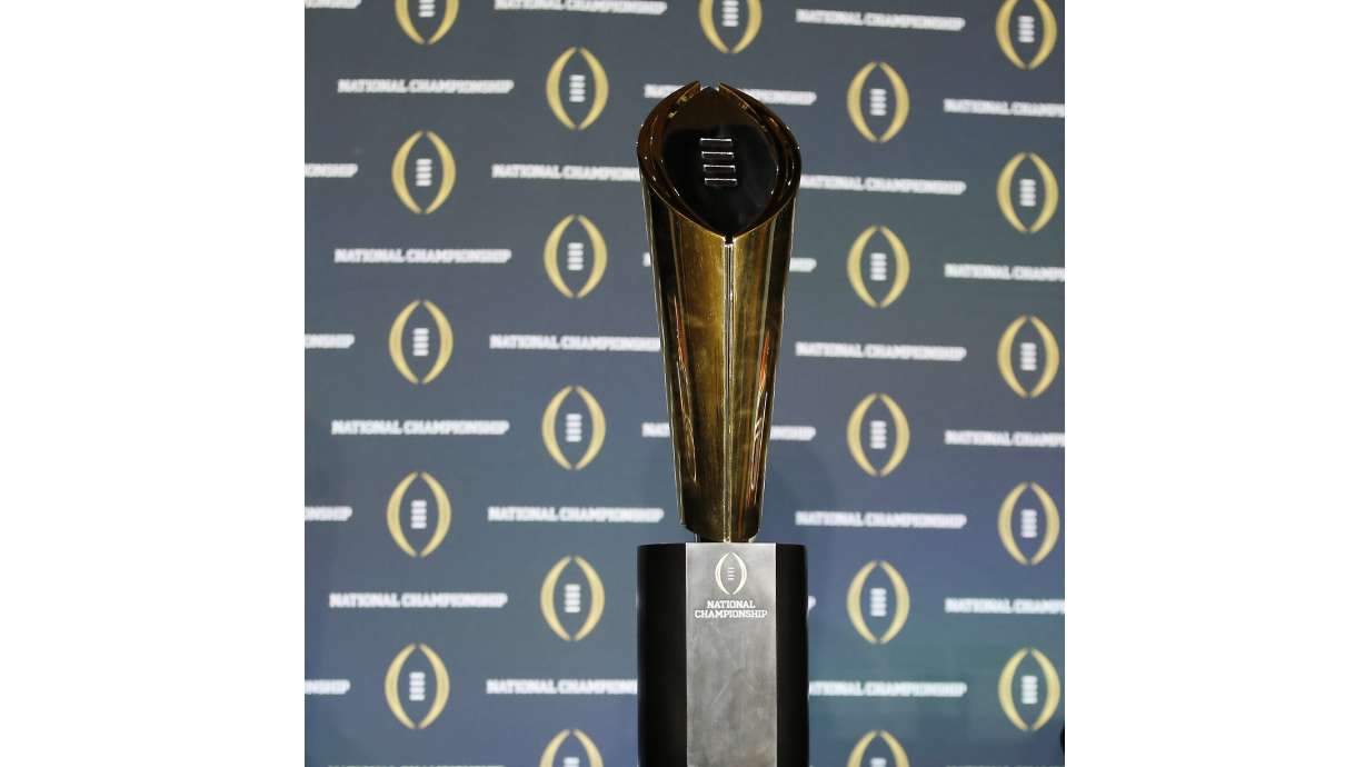 FILE - The national championship trophy is seen before a new conference for the NCAA college football playoff championship game between Clemson and Alabama, Sunday, Jan. 10, 2016, in Glendale, Ariz. The College Football Playoff announced Thursday, Dec. 1, 2022, it will expand to a 12-team event, starting in 2024, finally completing an 18-month process that was fraught with delays and disagreements.The announcement comes a day after the Rose Bowl agreed to amend its contract for the 2024 and '25 seasons, the last hurdle CFP officials needed cleared to triple the size of what is now a four-team format.