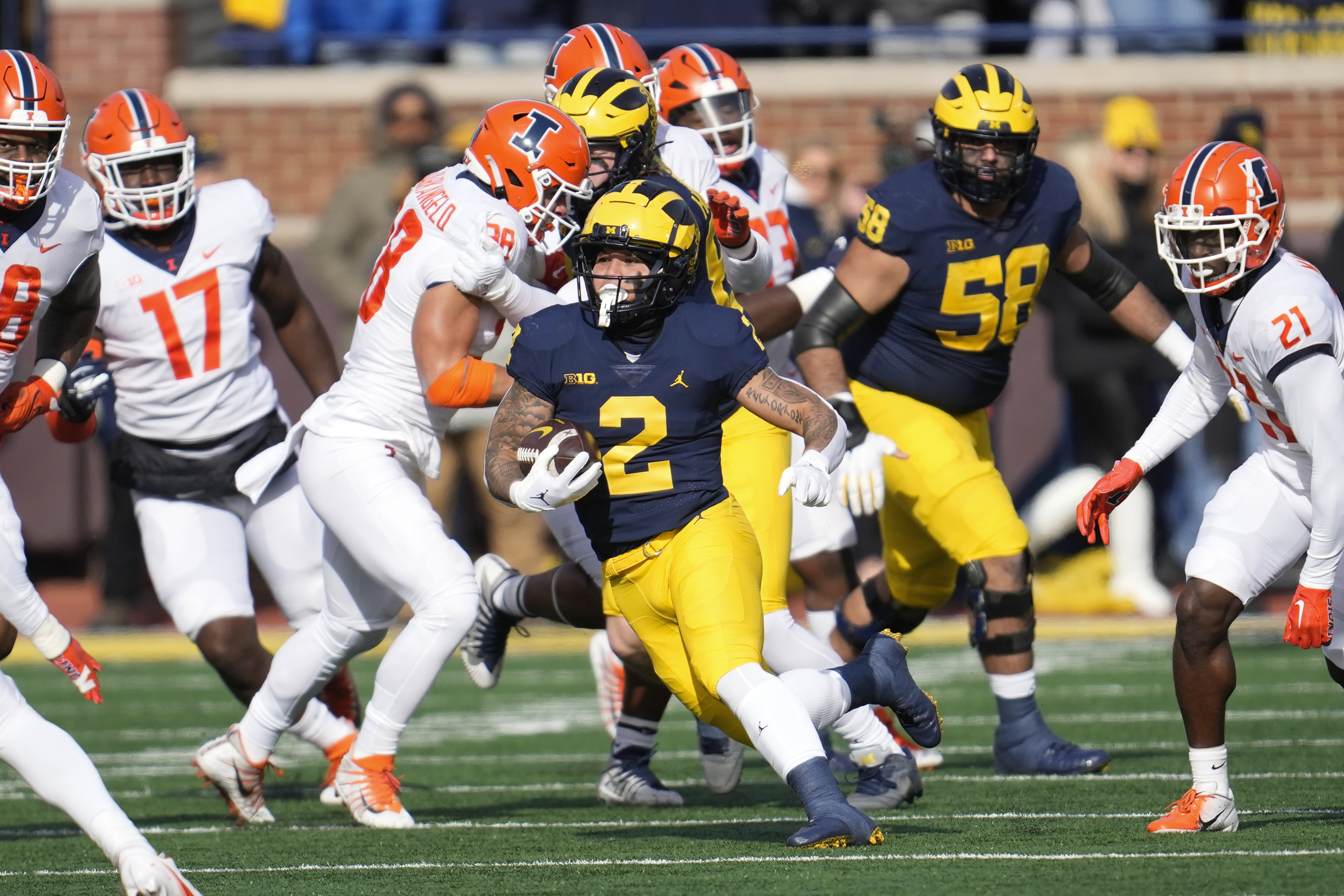 Michigan running back Blake Corum (2) runs the ball against Illinois in the first half of an NCAA college football game in Ann Arbor, Mich., Saturday, Nov. 19, 2022. 