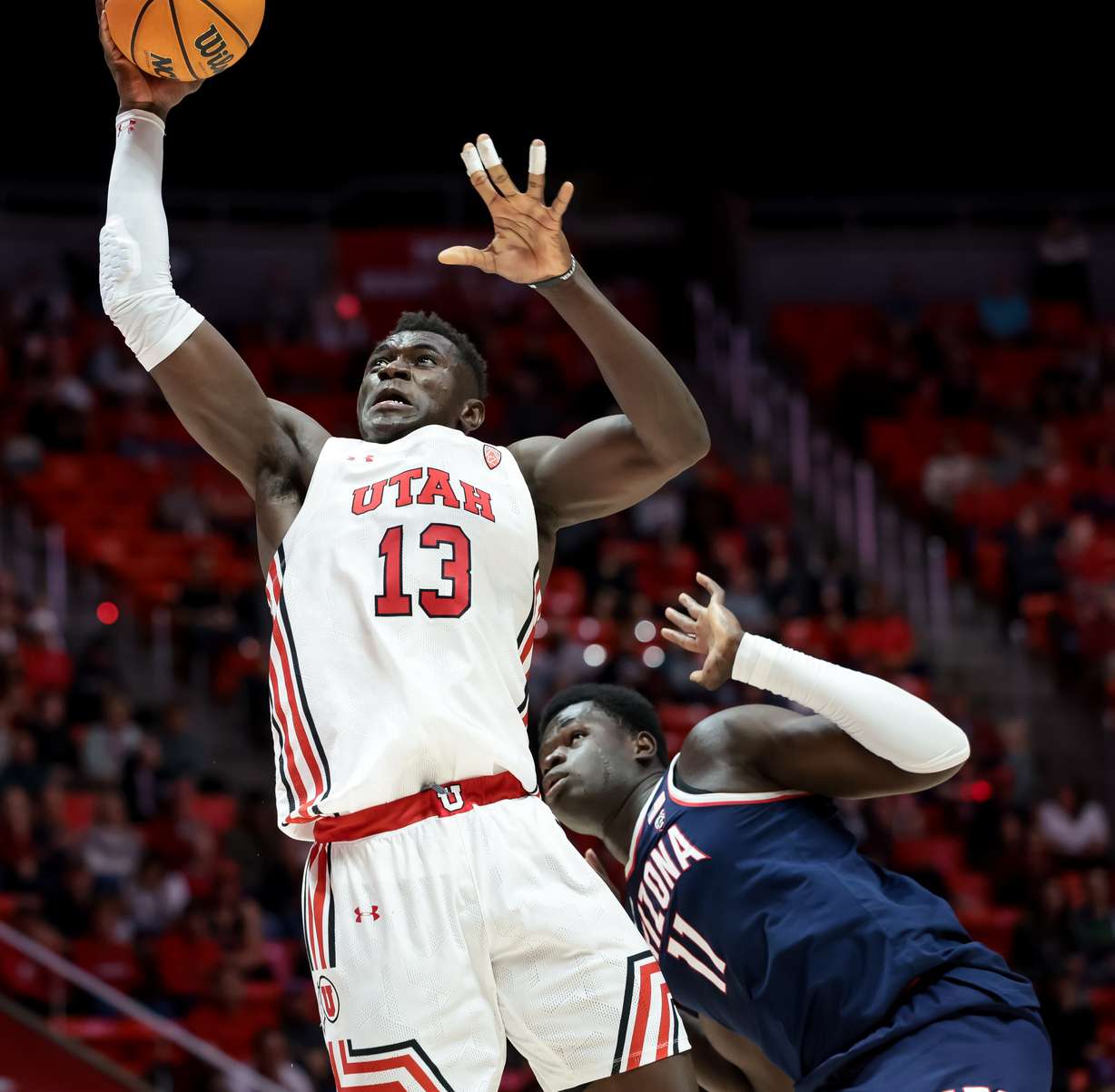 Utah Utes center Keba Keita (13) goes to the hoop ahead of Arizona Wildcats center Oumar Ballo (11) during the game at the Huntsman Center in Salt Lake City on Thursday, Dec. 1, 2022.