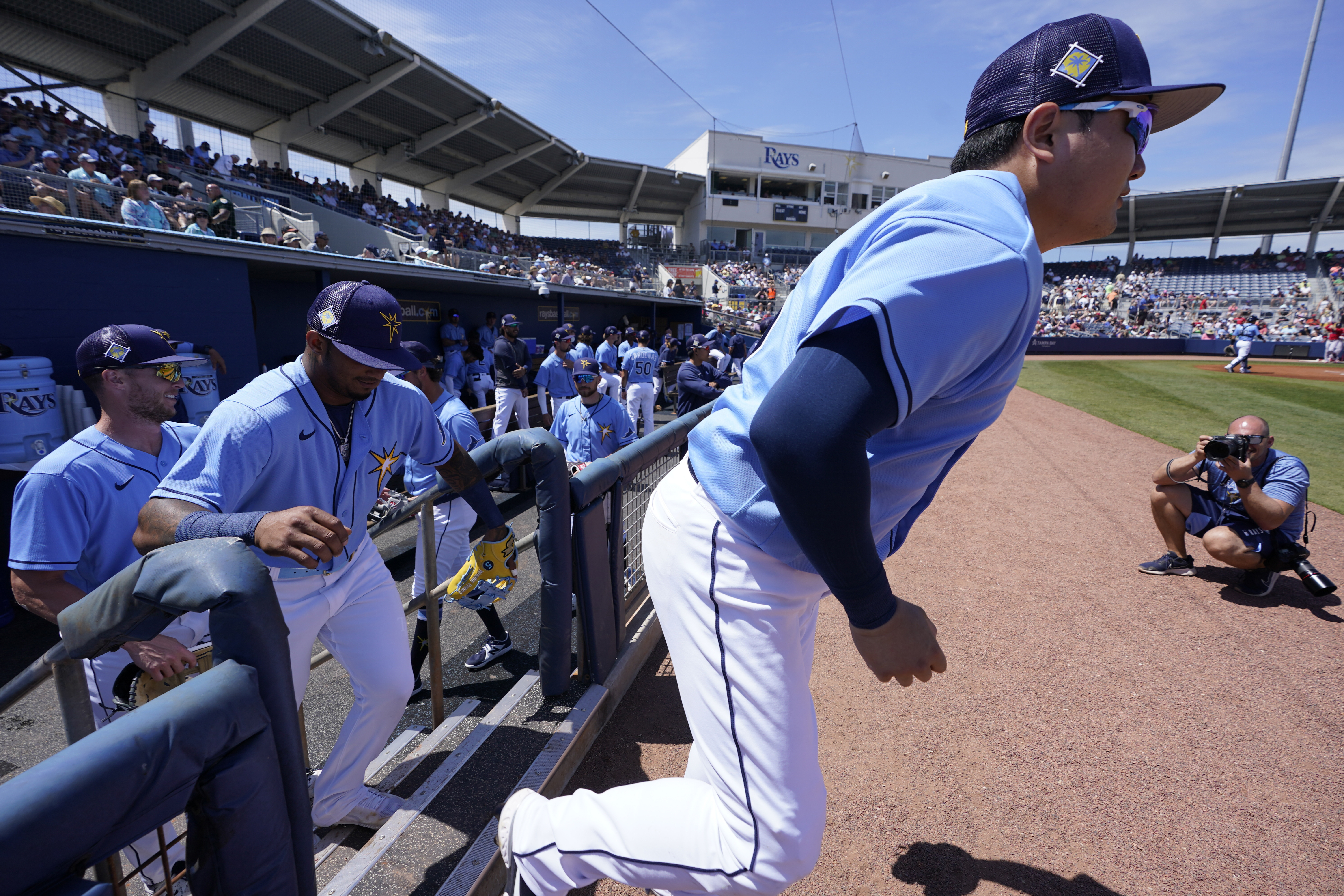 FILE - Tampa Bay Rays first baseman Ji-Man Choi, front right, is followed onto the field by shortstop Wander Franco prior to a spring training baseball game against the Boston Red Sox at Charlotte Sports Park, March 22, 2022, in Port Charlotte, Fla. The Rays are relocating their spring base for 2023 due to extensive damage to team training facilities caused by Hurricane Ian. The Rays have trained since 2009 in Port Charlotte, Florida, about 90 minutes south of St. Petersburg. 