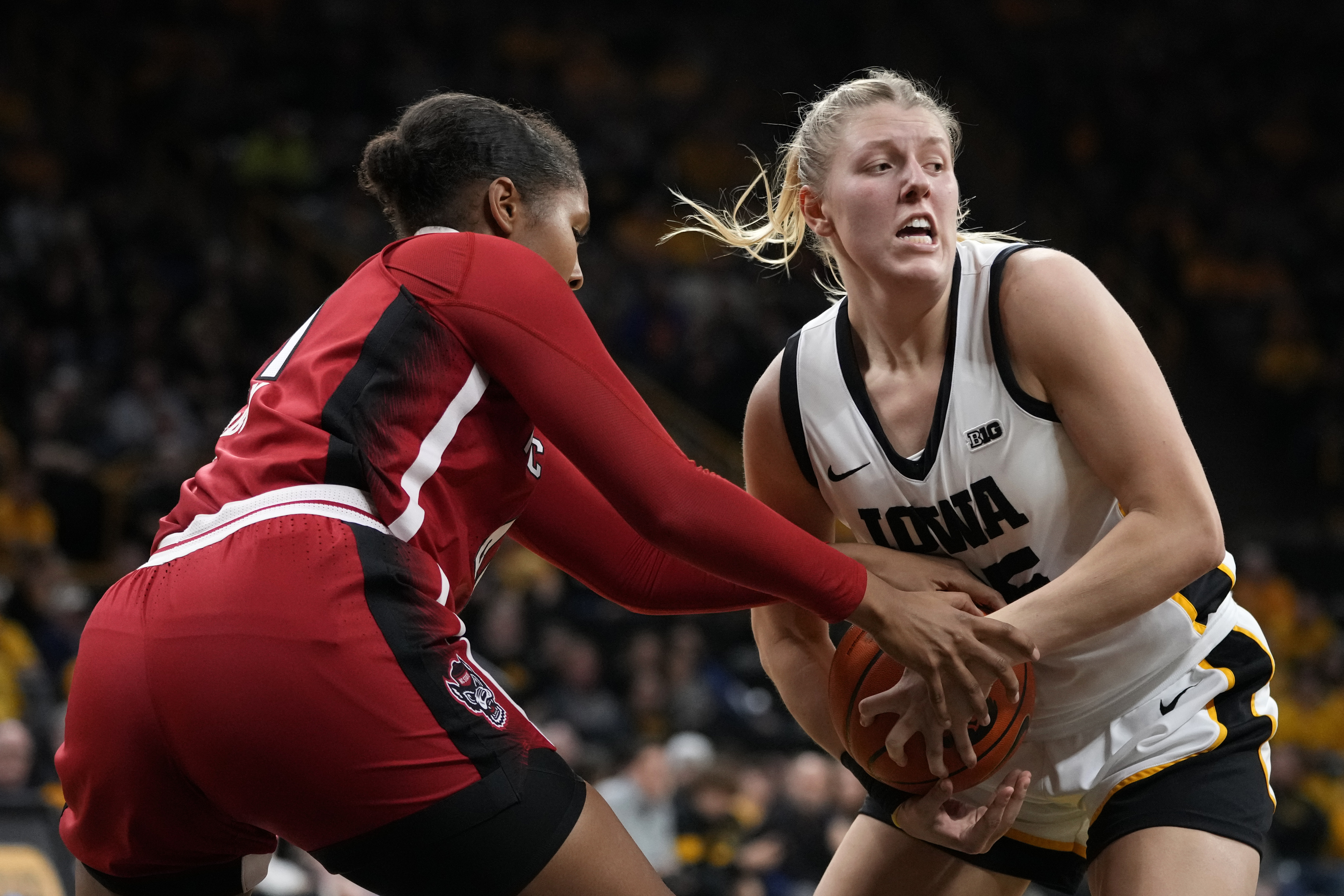 North Carolina State center Camille Hobby, left, tries to steal the ball from Iowa forward Monika Czinano during the second half of an NCAA college basketball game, Thursday, Dec. 1, 2022, in Iowa City, Iowa. North Carolina State won 94-81.