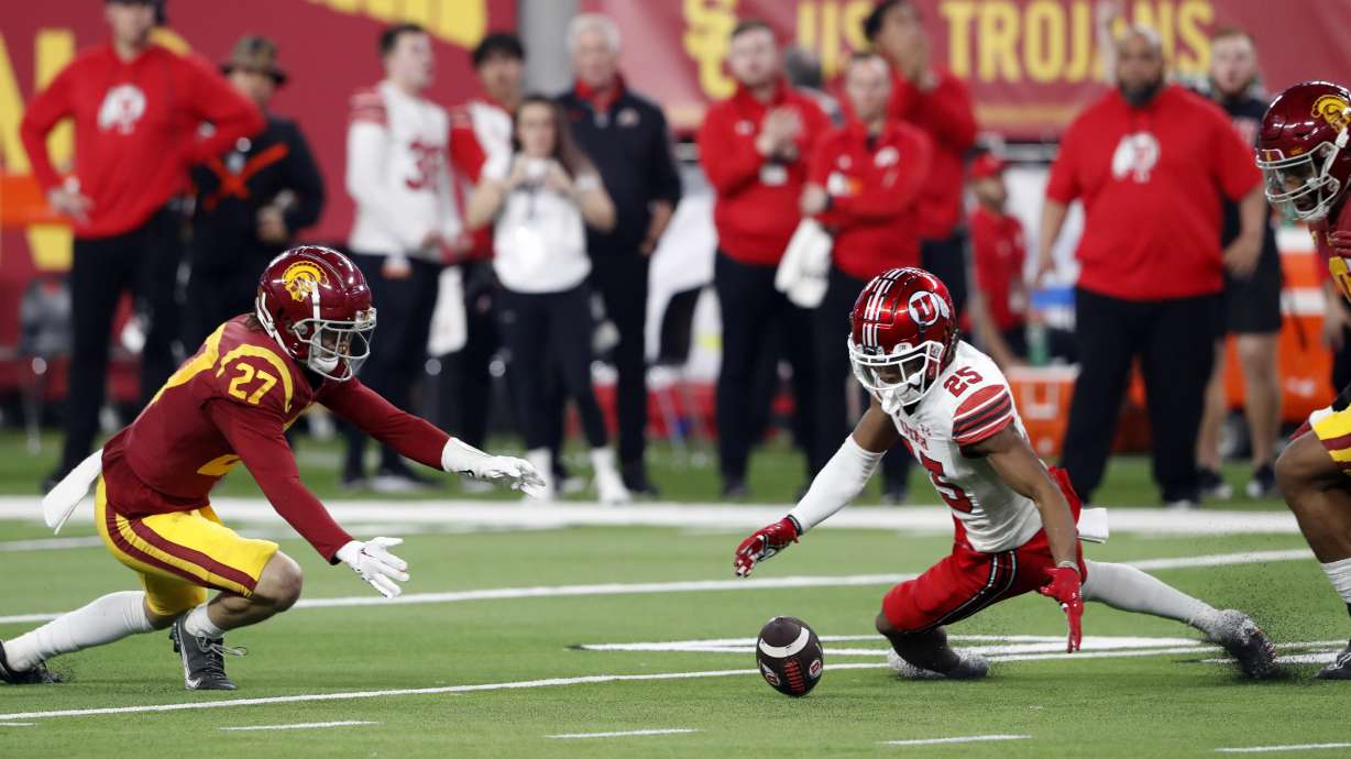 Utah wide receiver Jaylen Dixon (25) fumbles the ball during the first half of the Pac-12 Conference championship NCAA college football game against Southern California, Friday, Dec. 2, 2022, in Las Vegas. Southern California defensive back Bryson Shaw (27) recovered the fumble.
