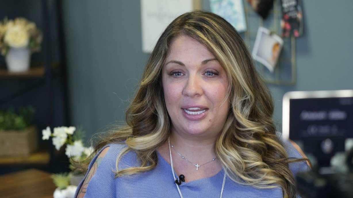 Web designer Lorie Smith is shown in her office on Nov. 7, in the southwest part of Littleton, Colo. The Supreme Court is being warned about the potentially dire consequences of a case next week involving Smith, a Christian graphic artist, who objects to designing wedding websites for same-sex couples.