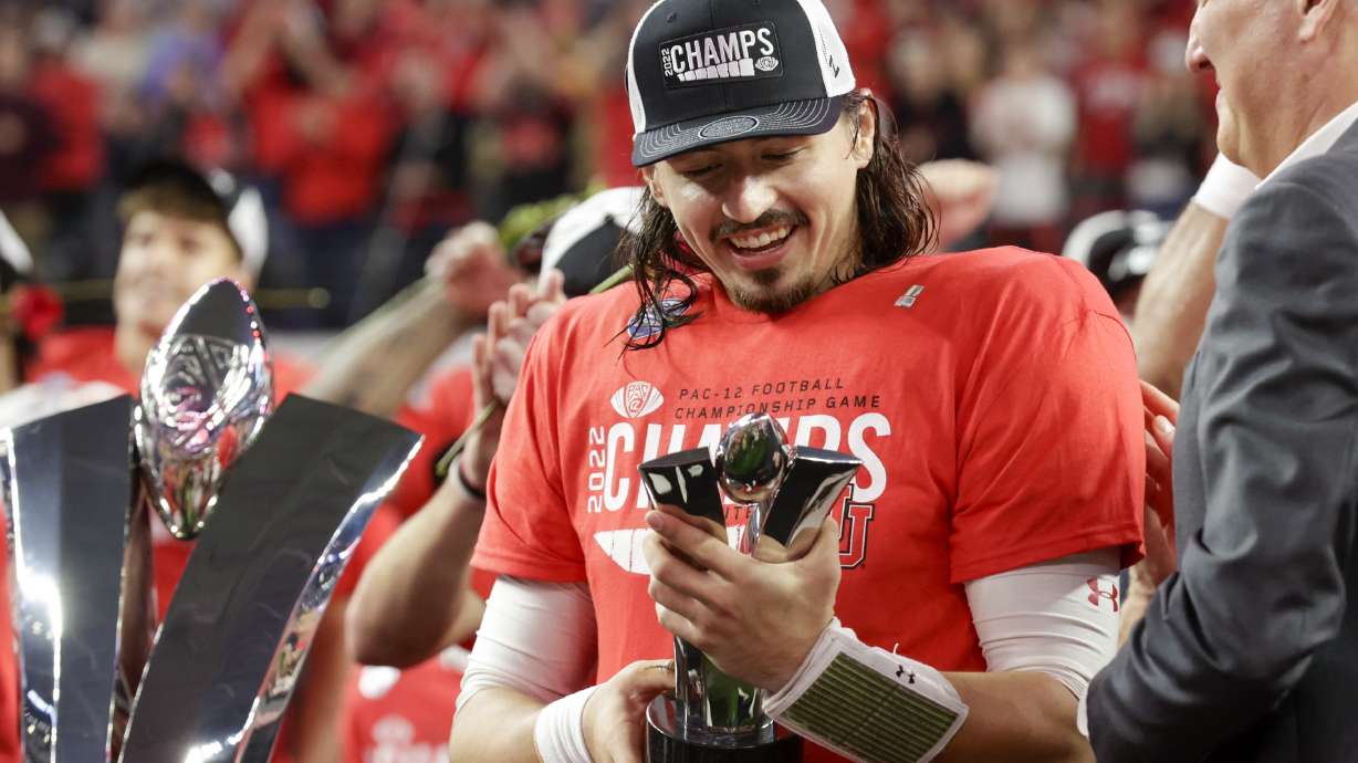 Utah Utes QB Cameron Rising holds the MVP trophy after winning the Pac-12 championship by beating the USC Trojans at the Allegiant Stadium in Las Vegas on Friday, Dec. 2, 2022. The Utes won 47-24.