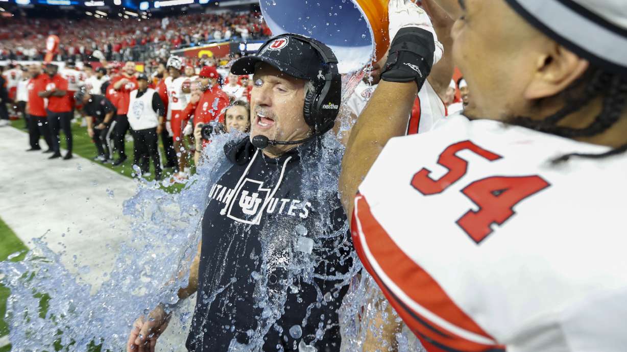 Utah Utes head coach Kyle Whittingham is doused in celebration before beating the USC Trojans in the Pac-12 Championship at the Allegiant Stadium in Las Vegas on Friday, Dec. 2, 2022. The Utes won 47-24.