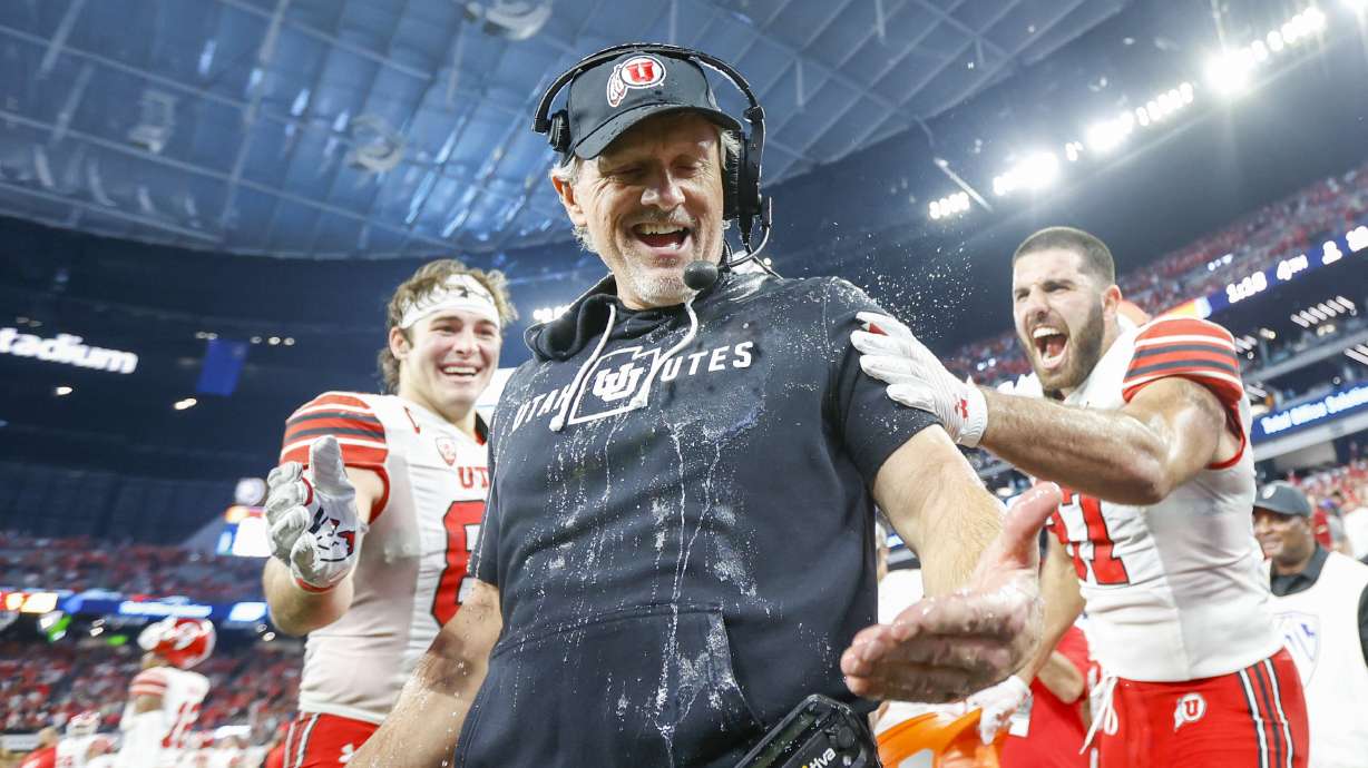 Utah Utes head coach Kyle Whittingham is doused in celebration before beating the USC Trojans in the Pac-12 Championship at the Allegiant Stadium in Las Vegas on Friday, Dec. 2, 2022. The Utes won 47-24.