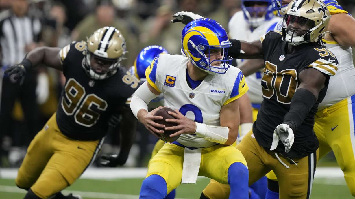 Los Angeles Rams quarterback Matthew Stafford, center, is sacked by New Orleans Saints defensive end Tanoh Kpassagnon (90) in the second half of an NFL football game in New Orleans, Sunday, Nov. 20, 2022.