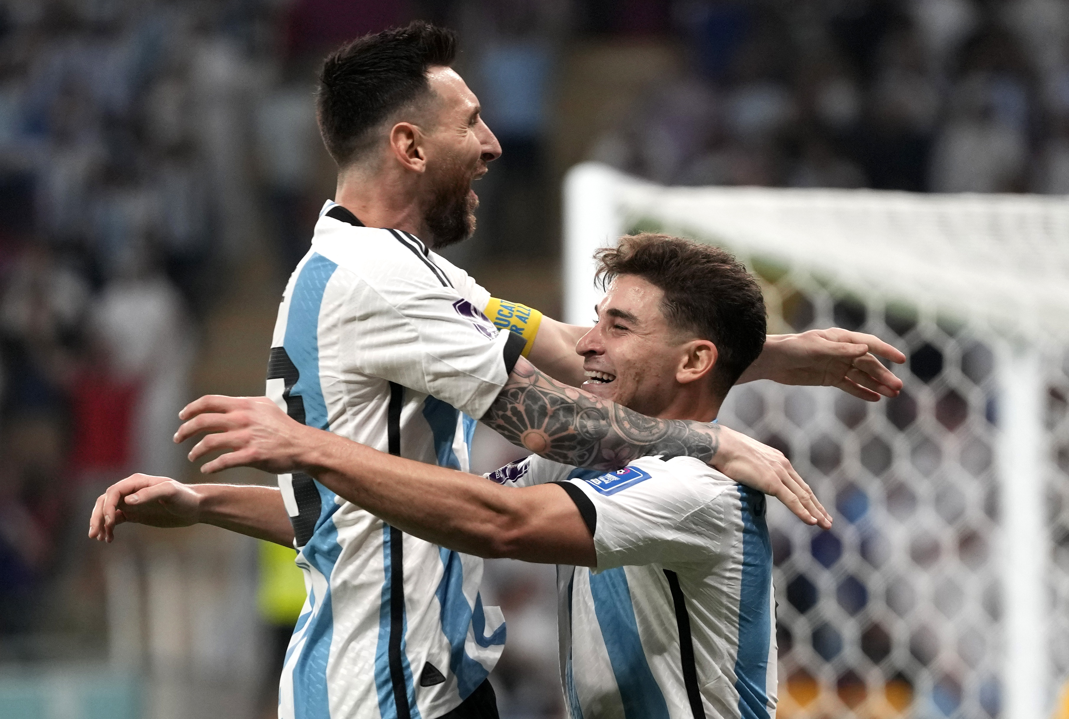Argentina's Julian Alvarez, right, and Lionel Messi, left, celebrate their side's second goal during the World Cup round of 16 soccer match between Argentina and Australia at the Ahmad Bin Ali Stadium in Doha, Qatar, Saturday, Dec. 3, 2022. 