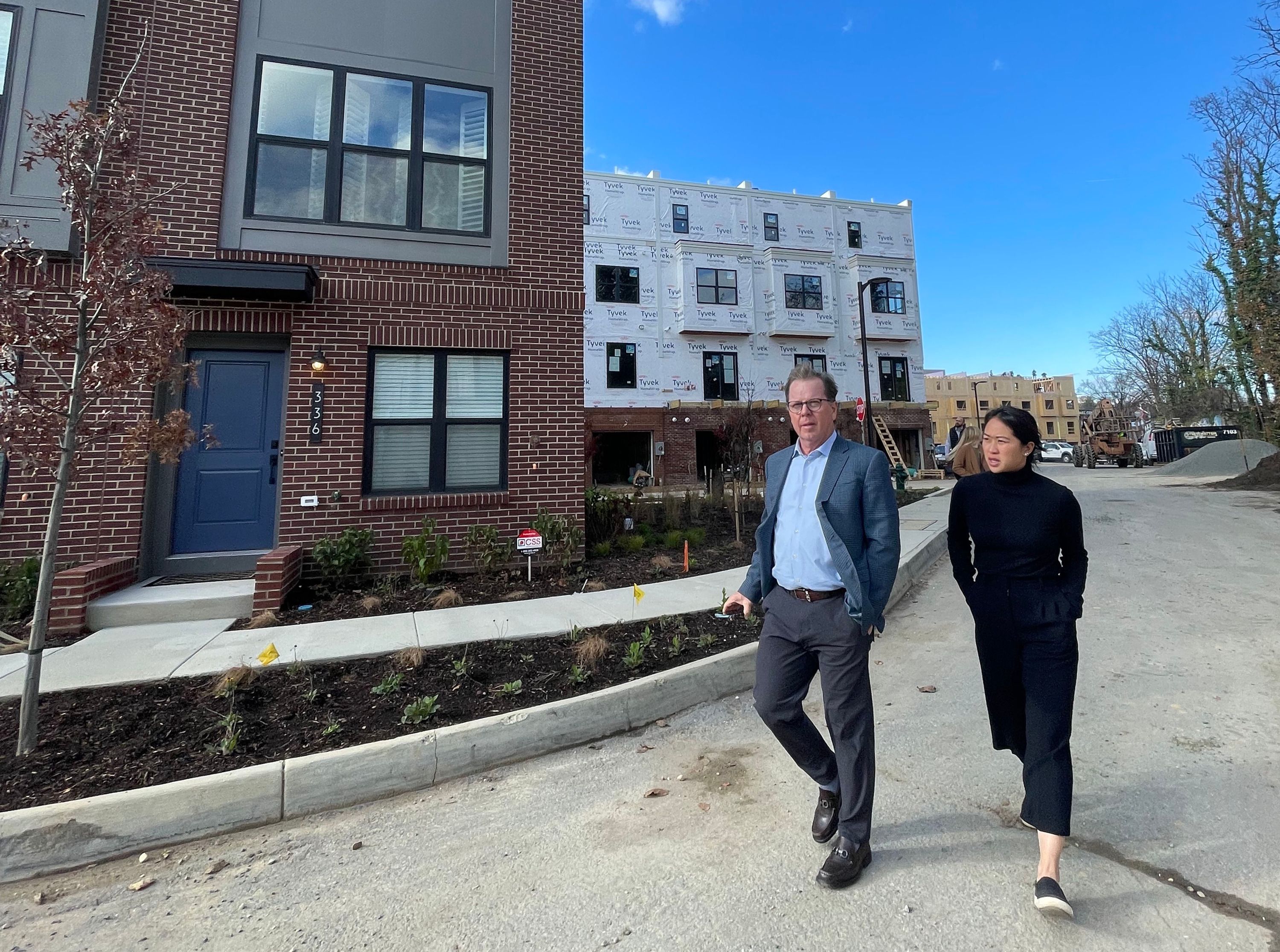 Clark Ivory, CEO of Ivory Homes, left, and Jenna Louie, director of strategy and operations at Ivory Innovations, tour new town houses in Washington, D.C., on Wednesday, Nov. 16, 2022.