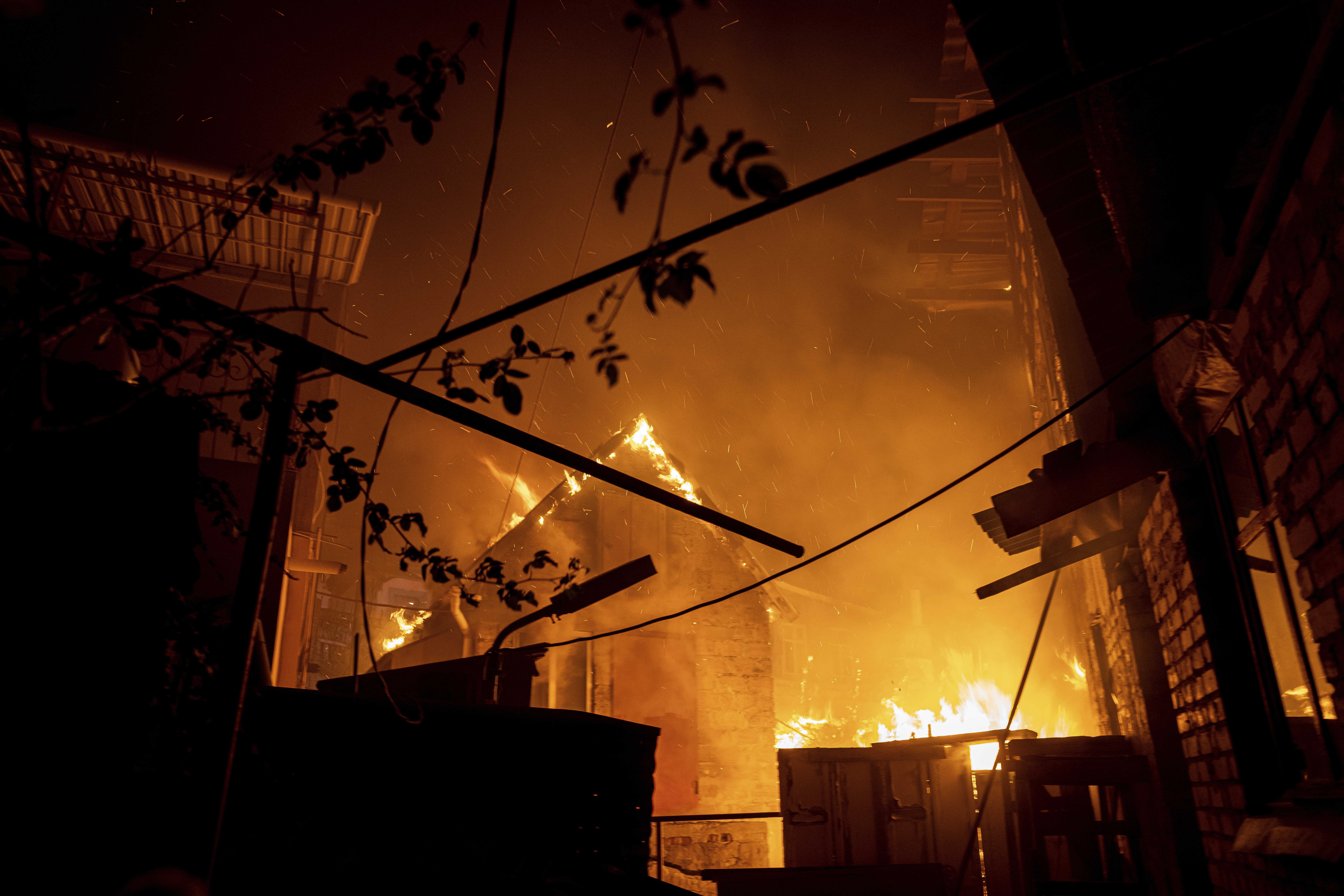 A house burns after a Russian attack in Kherson, Ukraine, Saturday.