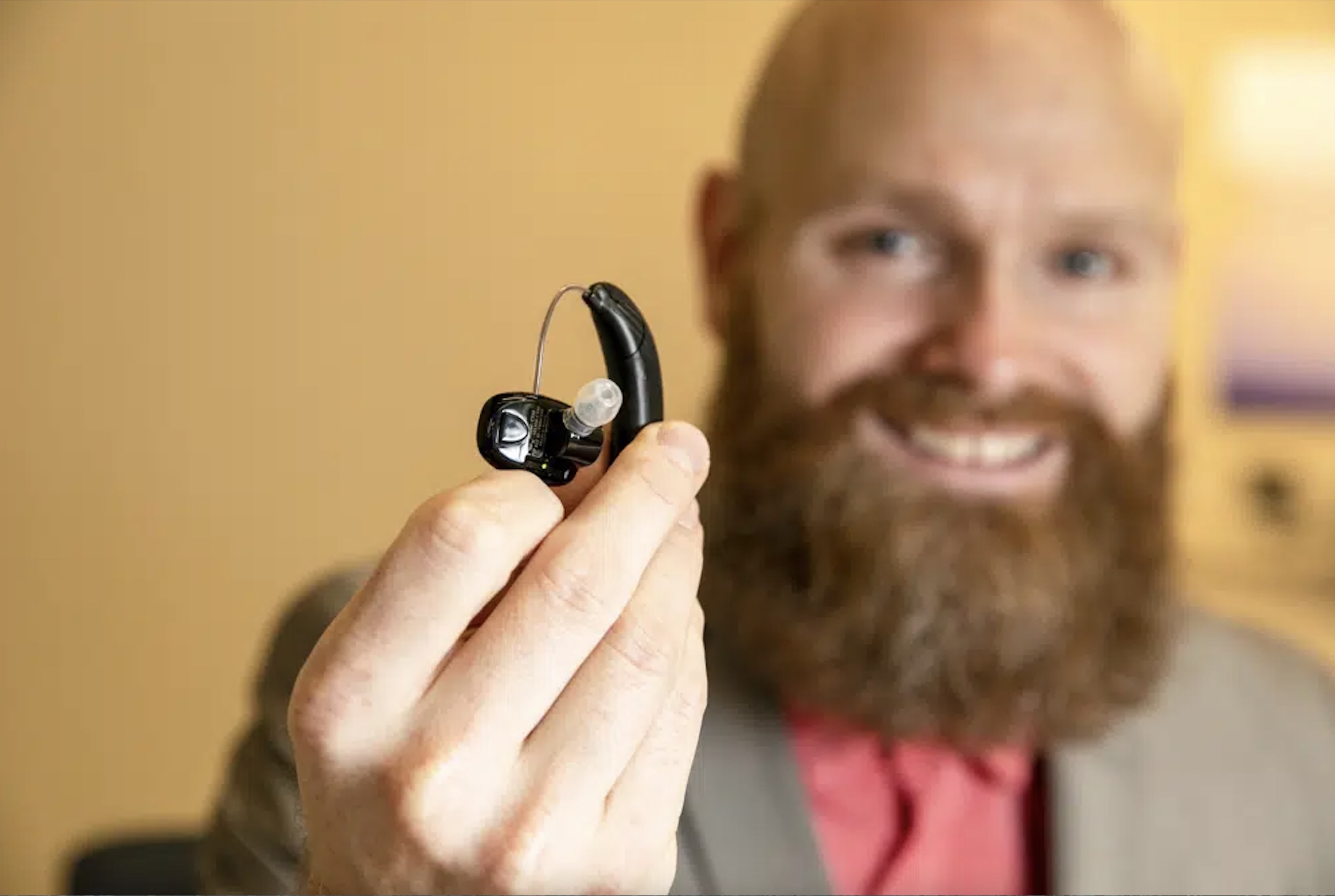 Sterling Sheffield, an assistant professor of Speech, Language, and Hearing Sciences at the University of Florida, holds an over-the-counter hearing aid Nov. 30, in Gainesville, Fla. OTC hearing aids started hitting the market in October after the FDA approved them for adults with mild-to-moderate hearing loss, and Sheffield has been testing them.