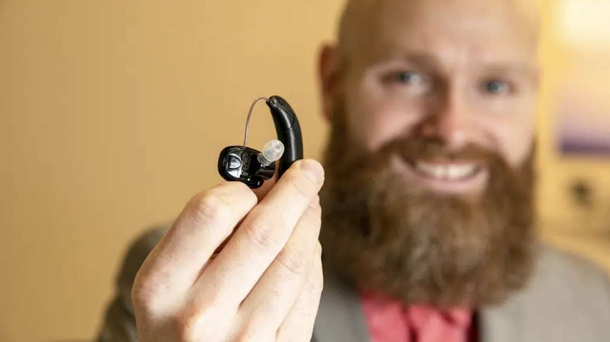 Sterling Sheffield, an assistant professor of Speech, Language, and Hearing Sciences at the University of Florida, holds an over-the-counter hearing aid Nov. 30, in Gainesville, Fla. OTC hearing aids started hitting the market in October after the FDA approved them for adults with mild-to-moderate hearing loss, and Sheffield has been testing them.