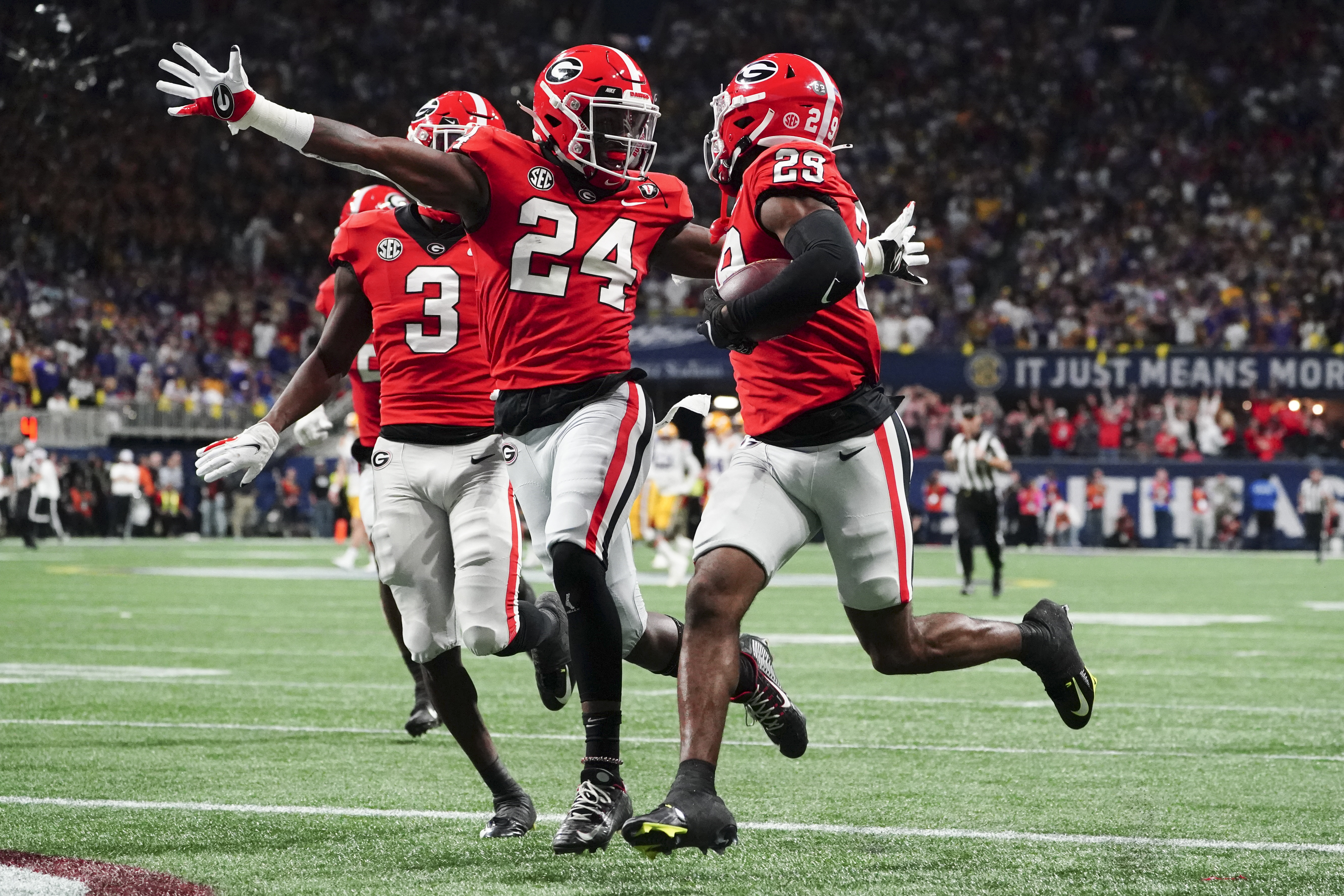 Georgia defensive back Malaki Starks (24) reacts as Georgia defensive back Christopher Smith (29) returns a blocked LSU field goal attempt for a touchdown in the first half of the Southeastern Conference Championship football game Saturday, Dec. 3, 2022 in Atlanta. 