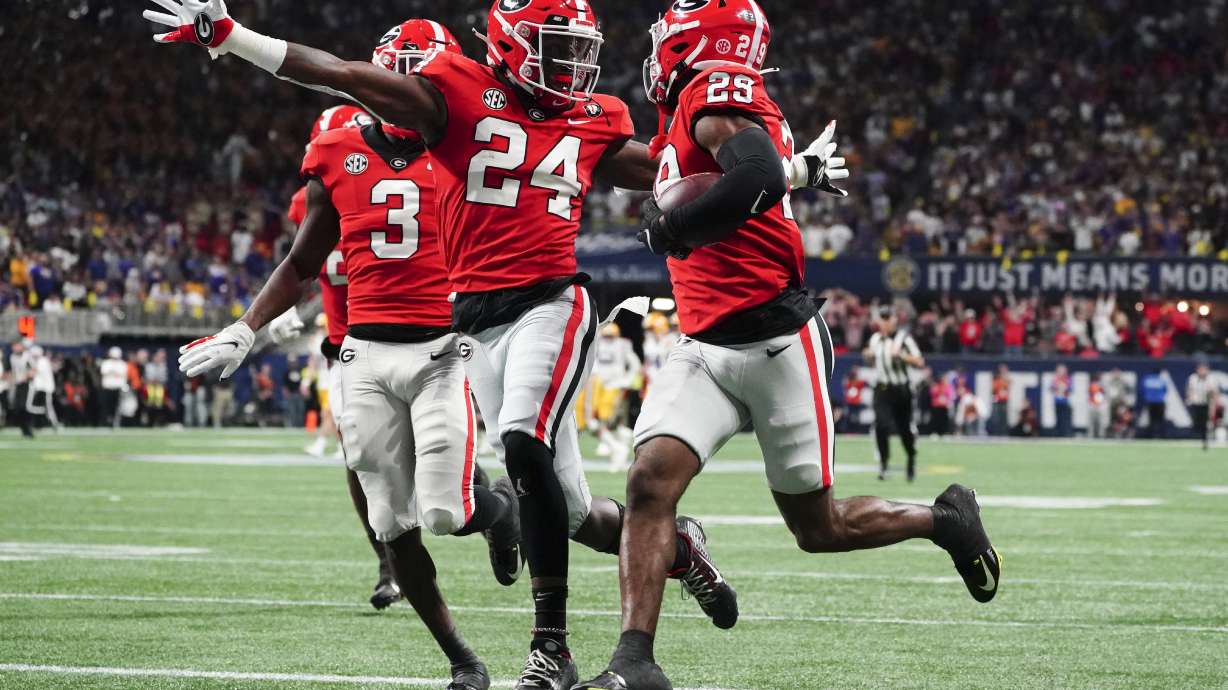 Georgia defensive back Malaki Starks (24) reacts as Georgia defensive back Christopher Smith (29) returns a blocked LSU field goal attempt for a touchdown in the first half of the Southeastern Conference Championship football game Saturday, Dec. 3, 2022 in Atlanta.