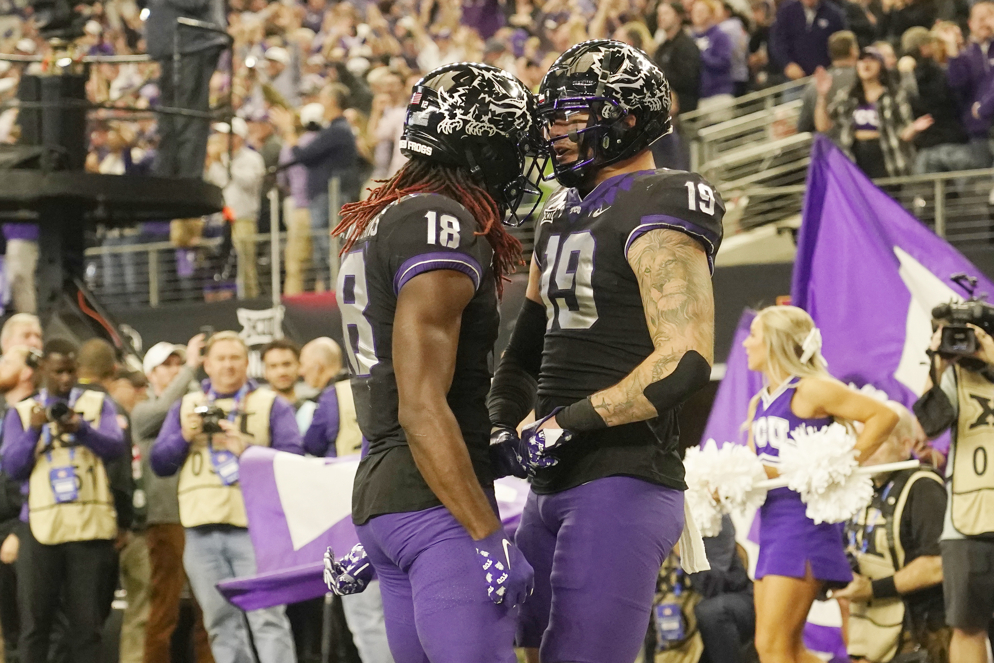 TCU tight end Jared Wiley (19) and wide receiver Savion Williams (18) celebrate a two-point conversion by Wiley in the second half of the Big 12 Conference championship NCAA college football game, Saturday, Dec. 3, 2022, in Arlington, Texas. 