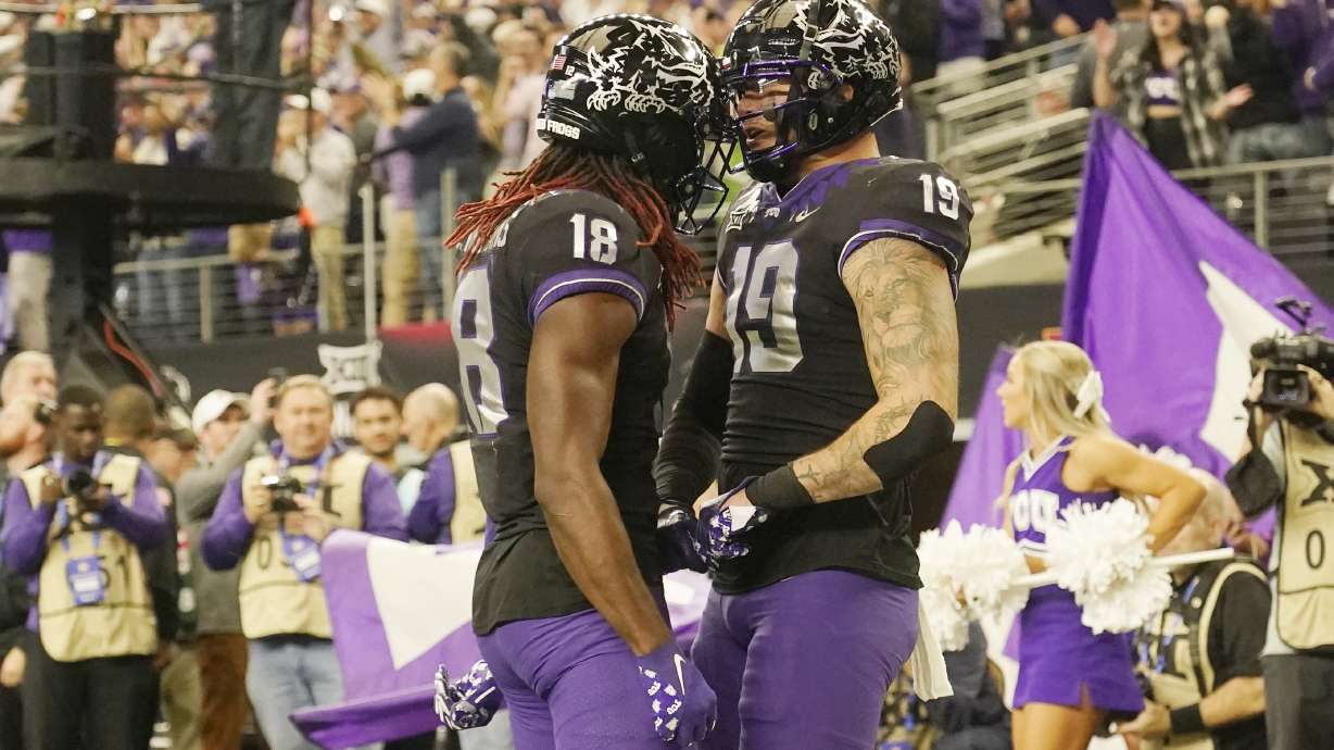 TCU tight end Jared Wiley (19) and wide receiver Savion Williams (18) celebrate a two-point conversion by Wiley in the second half of the Big 12 Conference championship NCAA college football game, Saturday, Dec. 3, 2022, in Arlington, Texas.