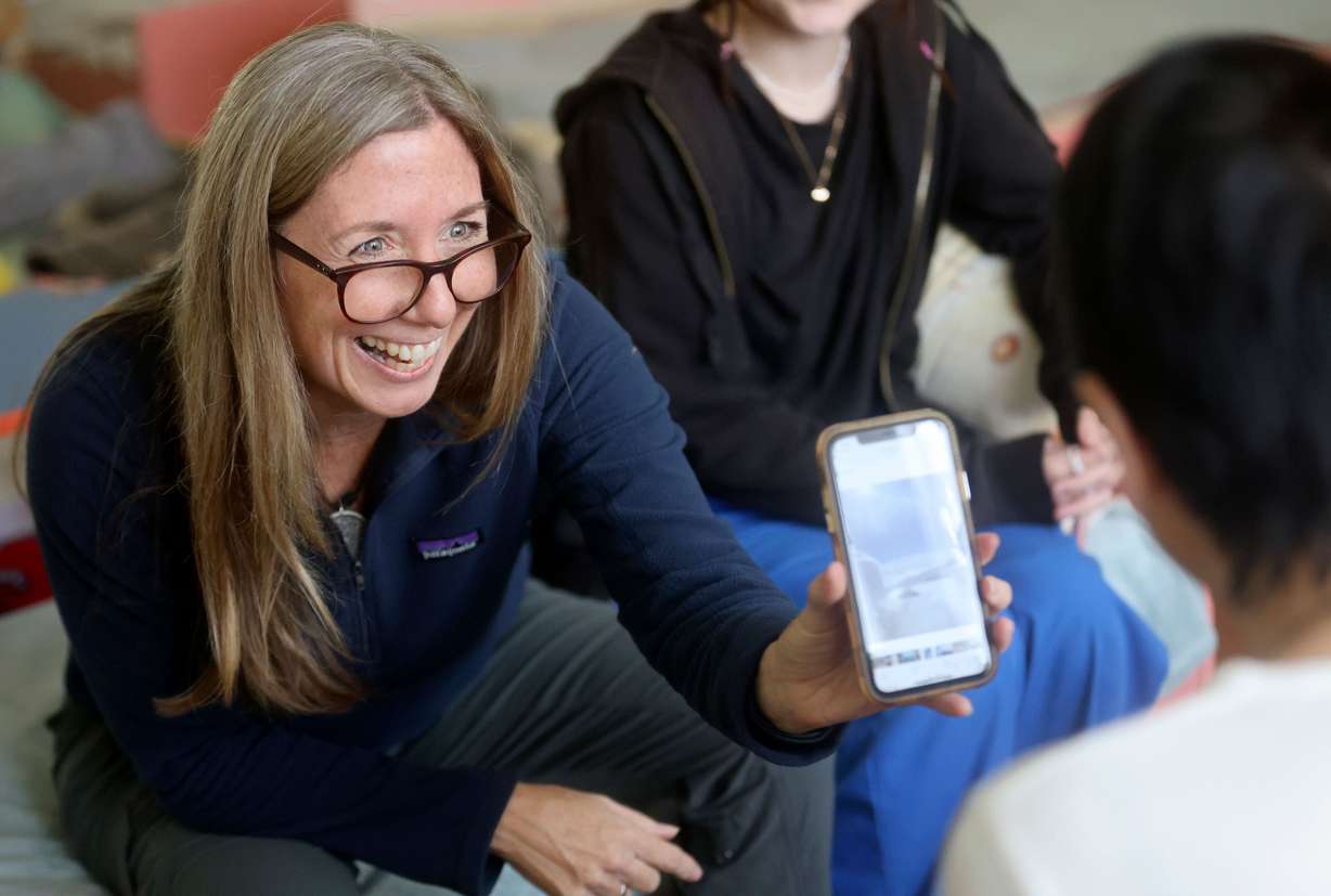 Liz Davis-Edwards, WelcomeNST CEO, shows Elvira Karnaukh what the view looks like from an airplane in Chervonohrad, Ukraine, on Sept. 17. Through the help of WelcomeNST, Karnaukh will take her first flight ever to move to Lehi, Utah, with her two children until it is safe to return to Ukraine and reunite with her husband and mother.