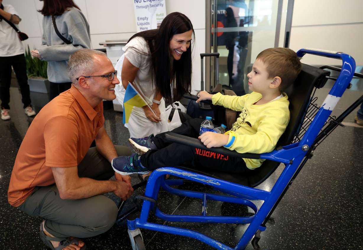 WelcomeNST team leader Jason Norby and his wife Kristin Norby talk to Ukrainian refugee Artem Karnaukh as he arrives at Salt Lake City International Airport in Salt Lake City on Sept. 21. Norby and his family hosted Karnaukh, his mother and his sister until they could find an apartment of their own.