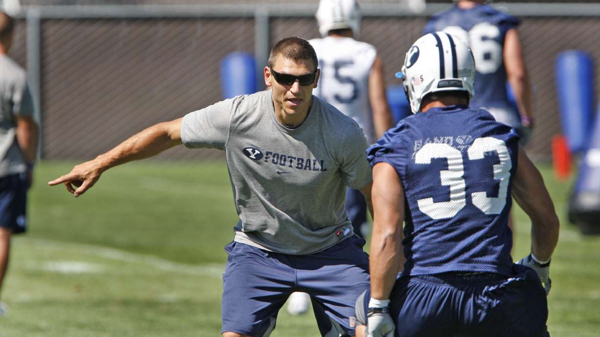 Defense coach Kelly Poppinga runs drills with Bryan Kariya during BYU football practice Monday, Aug. 8, 2011, in Provo. Poppinga is returning to BYU as a defensive assistant and special teams coordinator after coaching at Virginia and Boise State.