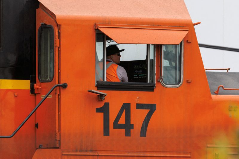 A railway worker drives a train engine while loading railcars in San Diego, Calif., Nov. 30.