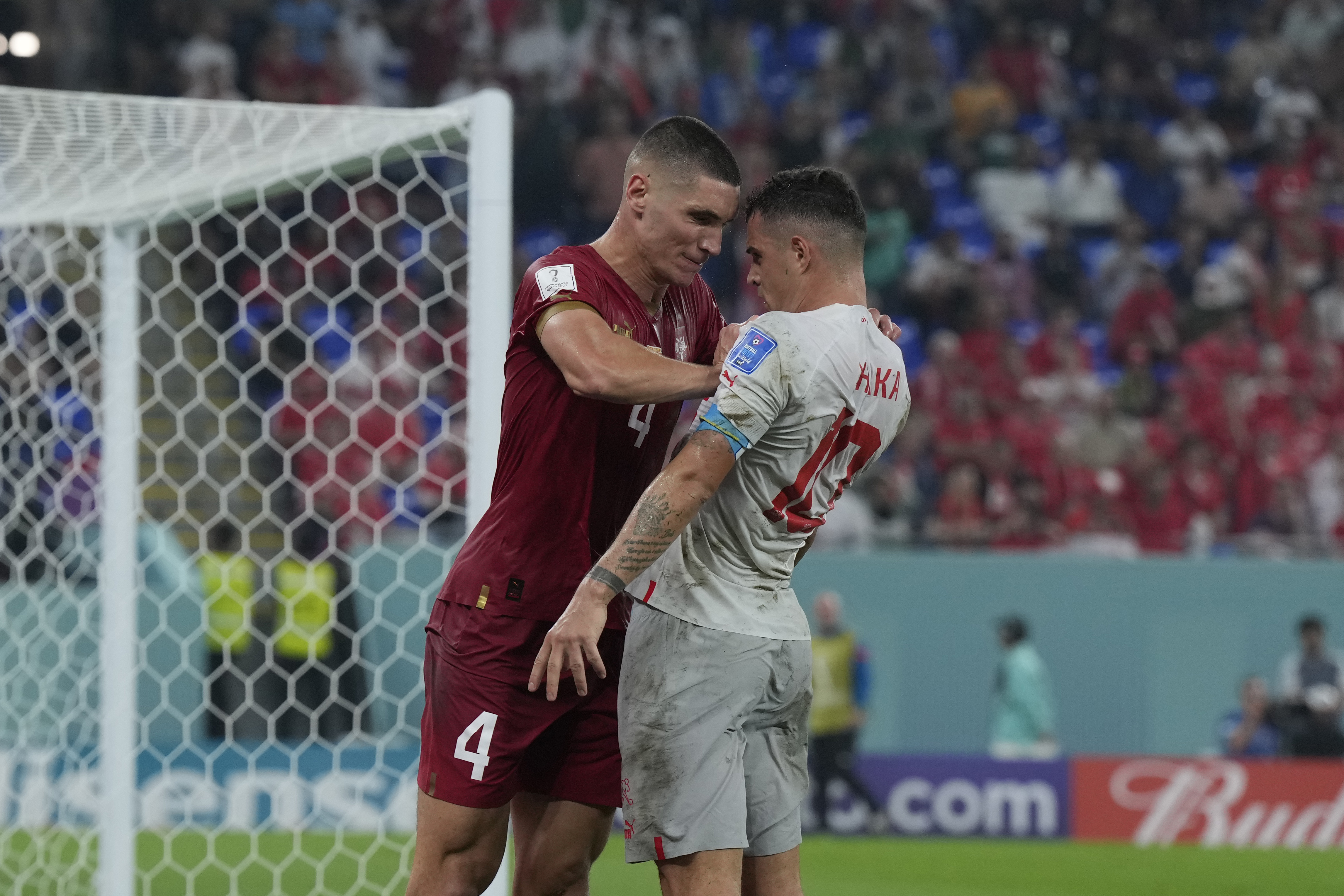 Serbia's Nikola Milenkovic, left, pushes Switzerland's Granit Xhaka during the World Cup group G soccer match between Serbia and Switzerland, in Doha, Qatar, Friday Dec. 2, 2022. 